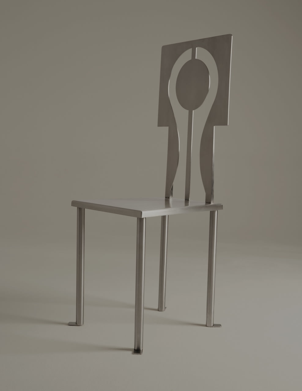Luna chair profile view showing curved cutout backrest design