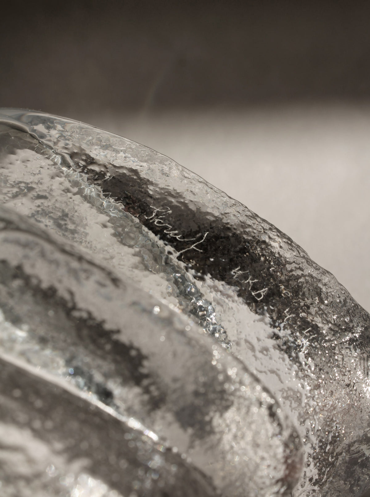 Close-up detail of textured crystal glass surface with bubbles