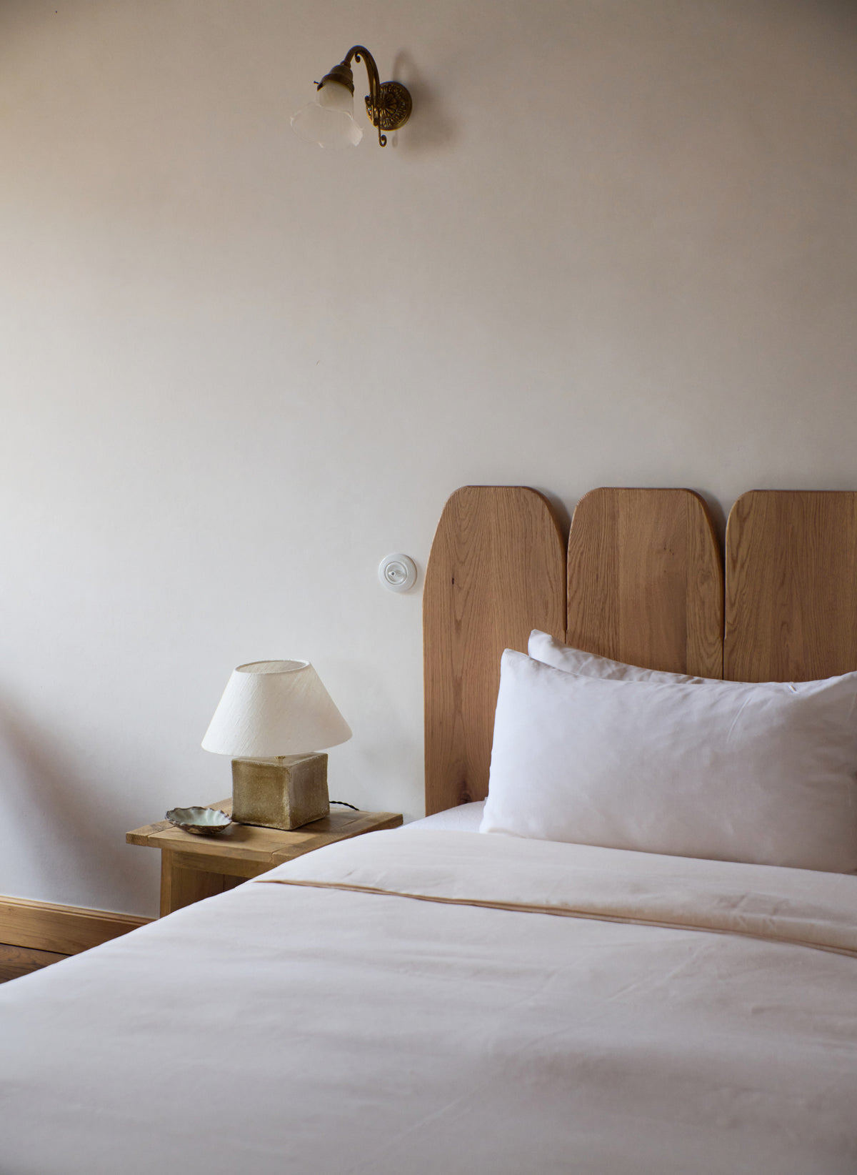 Arouca Table Light Red — positioned on bedside table in neutral bedroom
