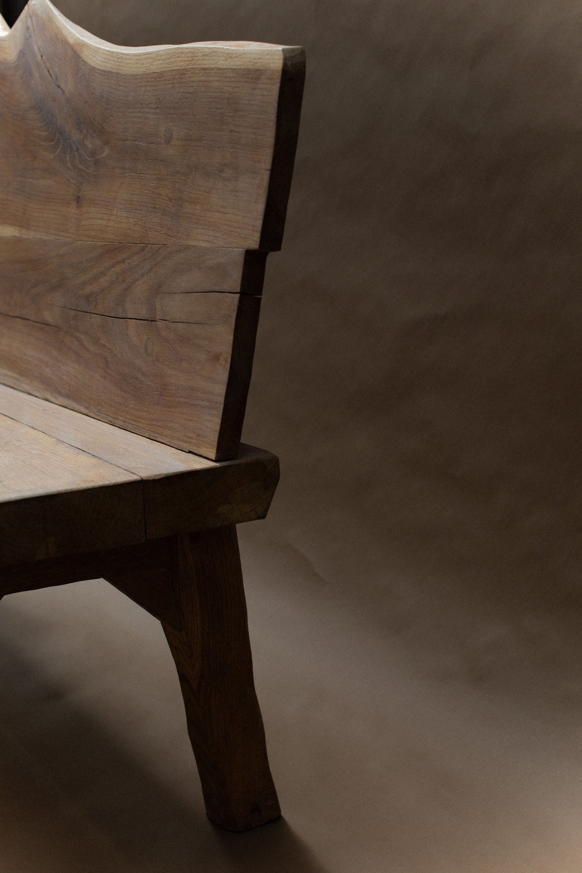 Close-up detail of brutalist oak bench backrest and leg joint