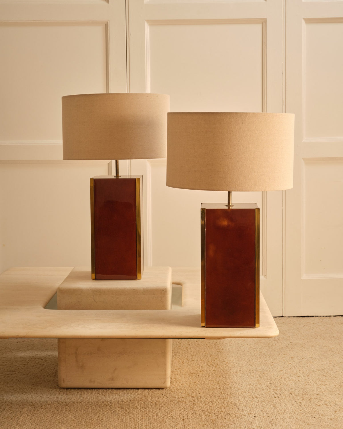 Pair of table lamps - Italy 1970s — positioned on marble table with beige shades