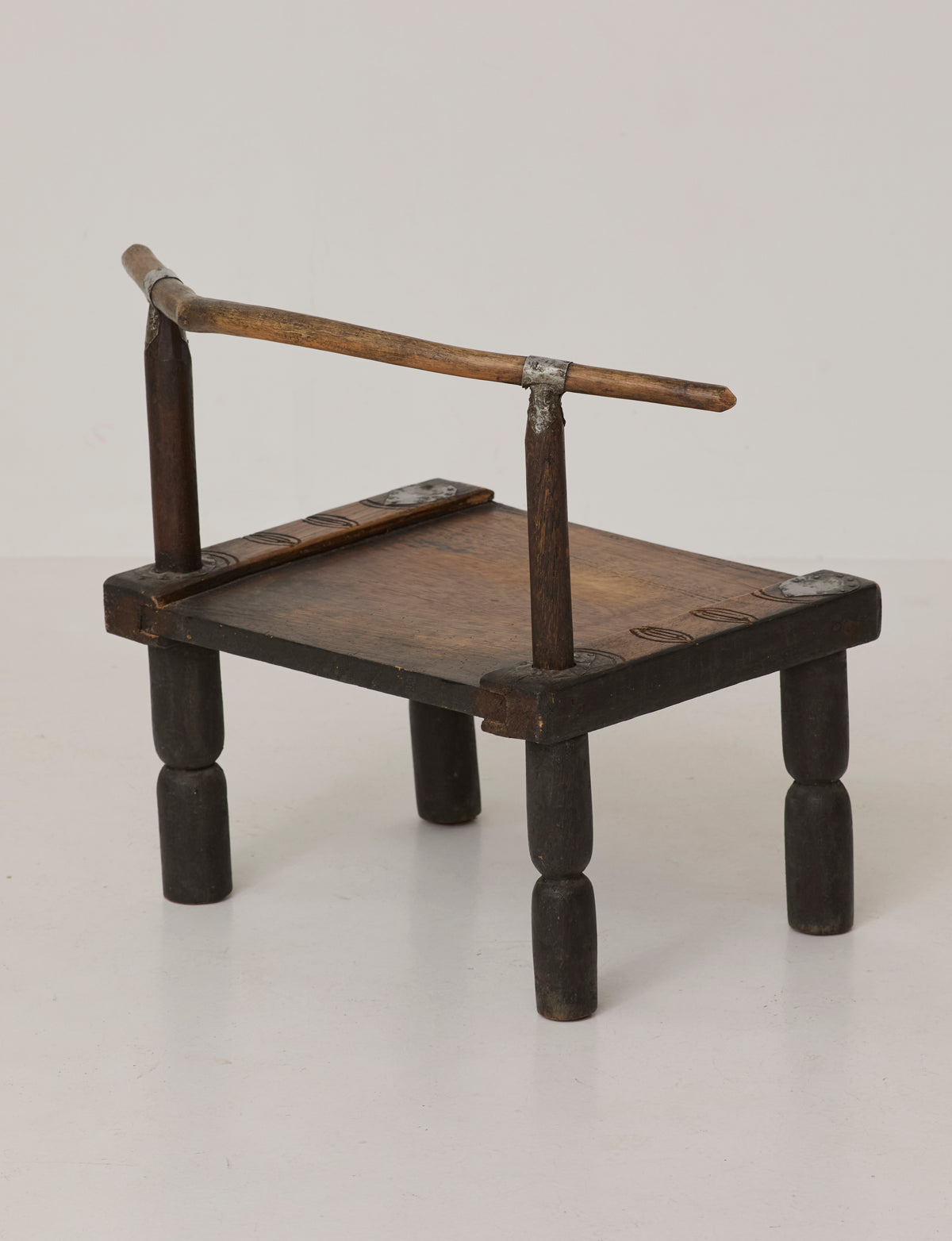 Small artisanal vintage West African chair "Baoulé" in solid wood C. 1960 — lifestyle setting