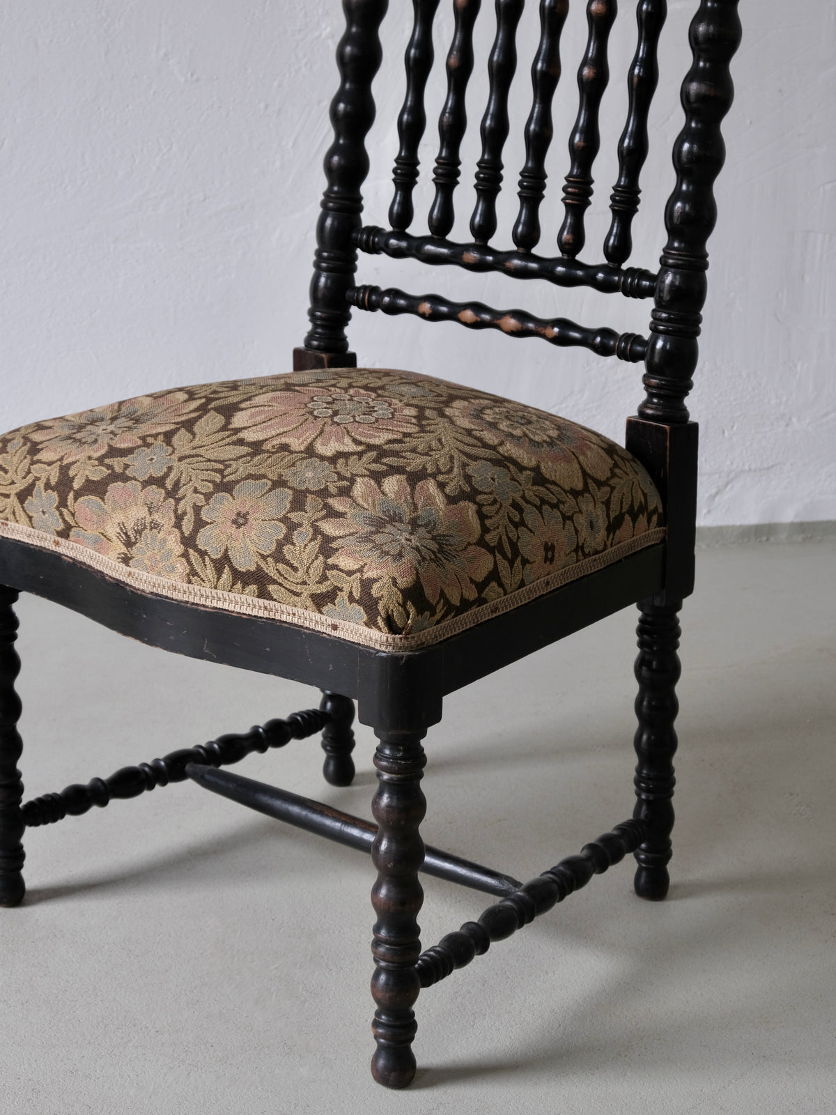 French oak bobbin chair detail showing turned spindles and floral upholstery