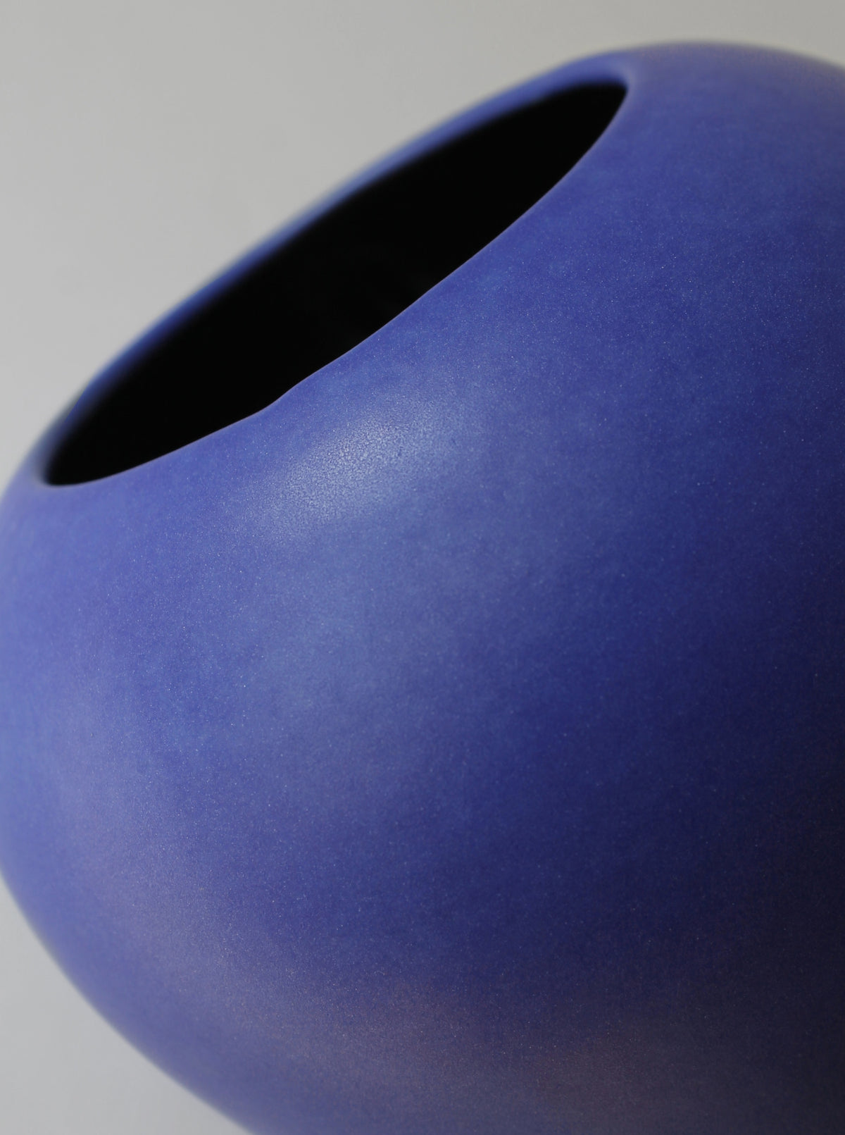 Close-up detail of cobalt blue matte ceramic vase opening