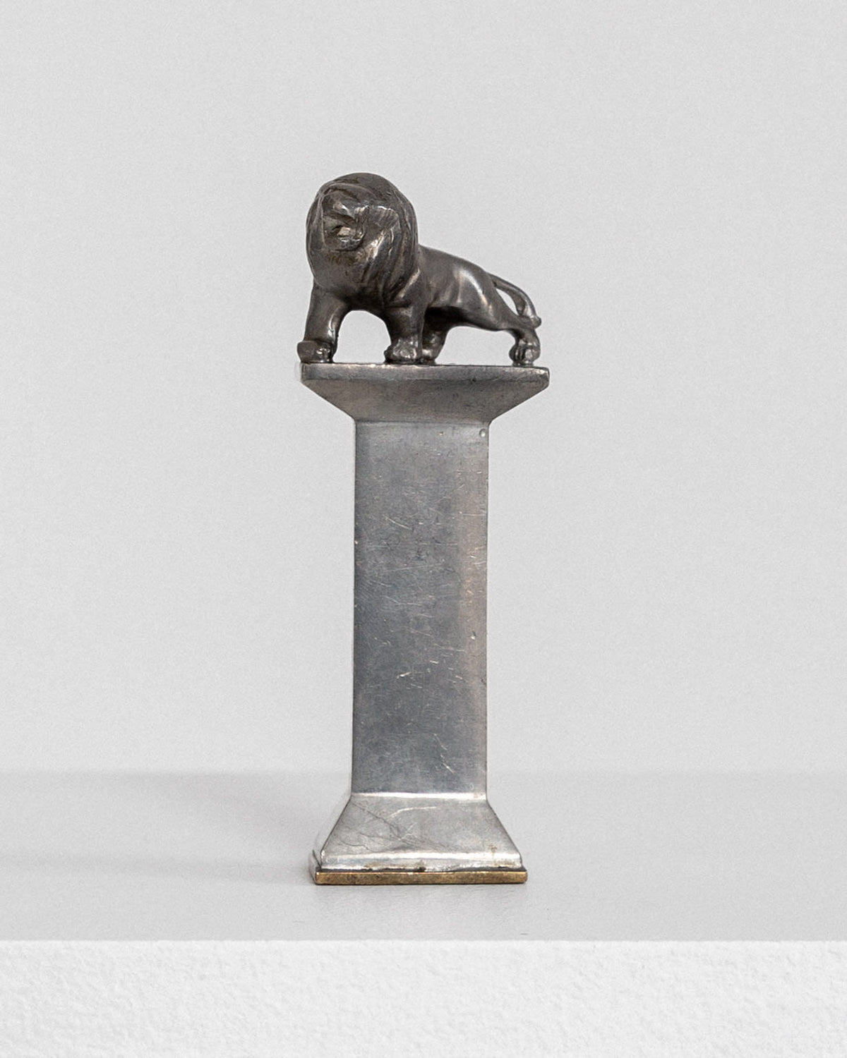 Art Deco pewter seal stamp with lion sculpture on marble column