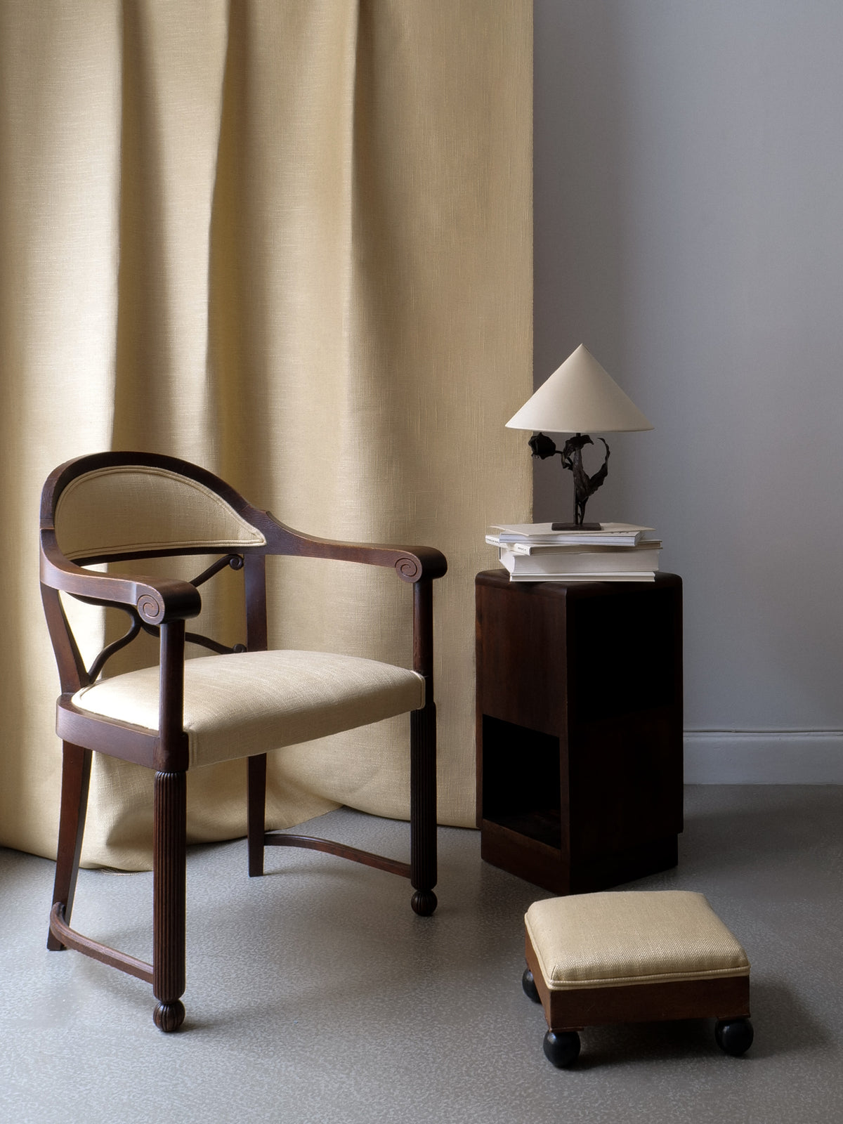 Lifestyle view of Swedish 1800s ottoman stool with cream upholstery