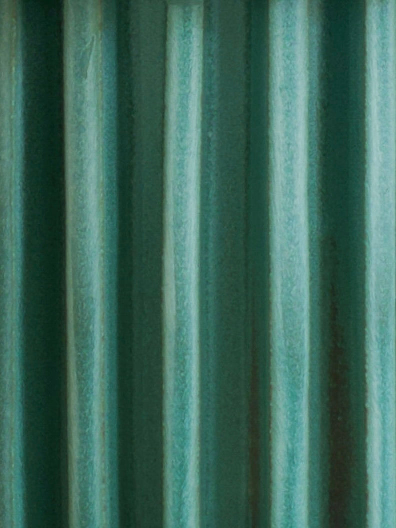 Close-up of green corrugated metal from Devin Wilde’s Vessel No. IV, highlighting vertical ridges and soft shadows for an industrial, textured look.