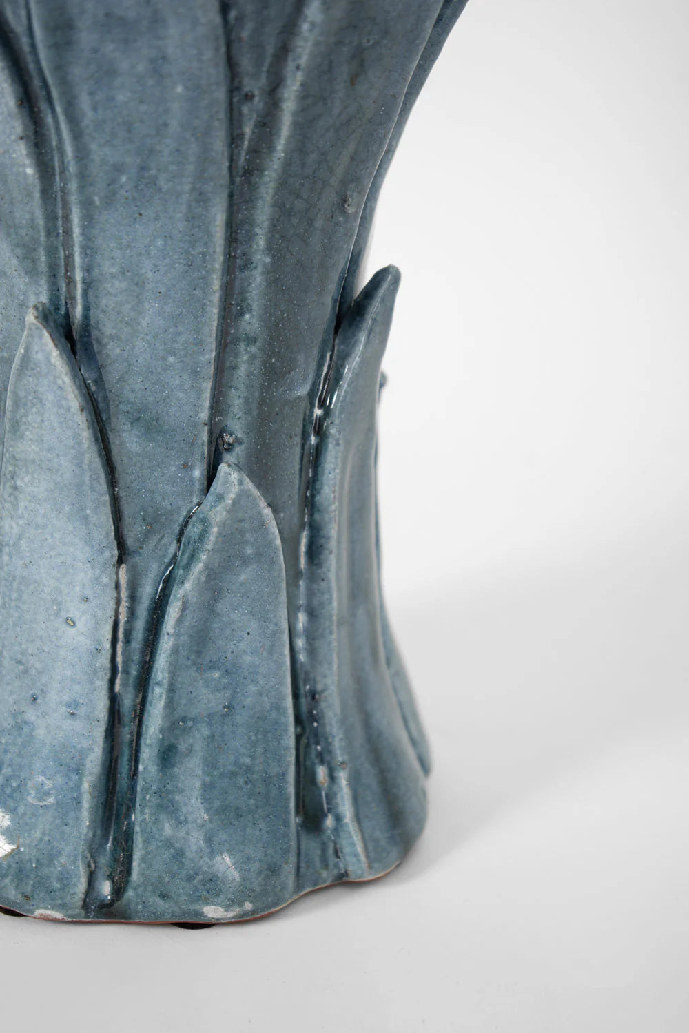 Close-up of the "Sintra" Blue Table Lamp by Barracuda Interiors, featuring a glossy ceramic base with textured leaf-like patterns, inspired by Portuguese design, set against a plain white background.