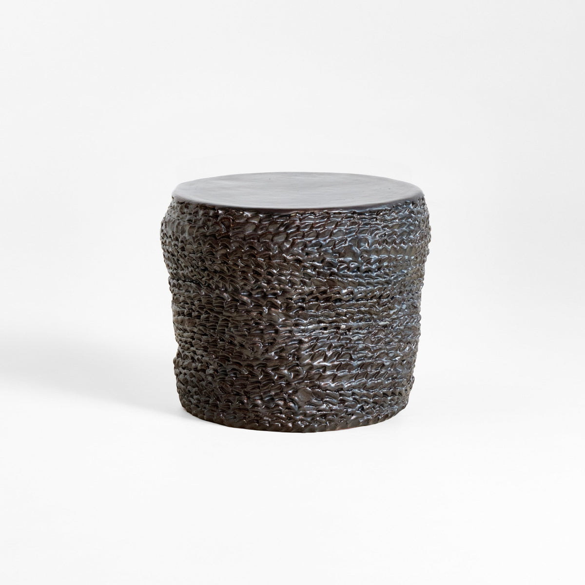 Casa Ceramic Side Table — close-up of textured dark ceramic surface