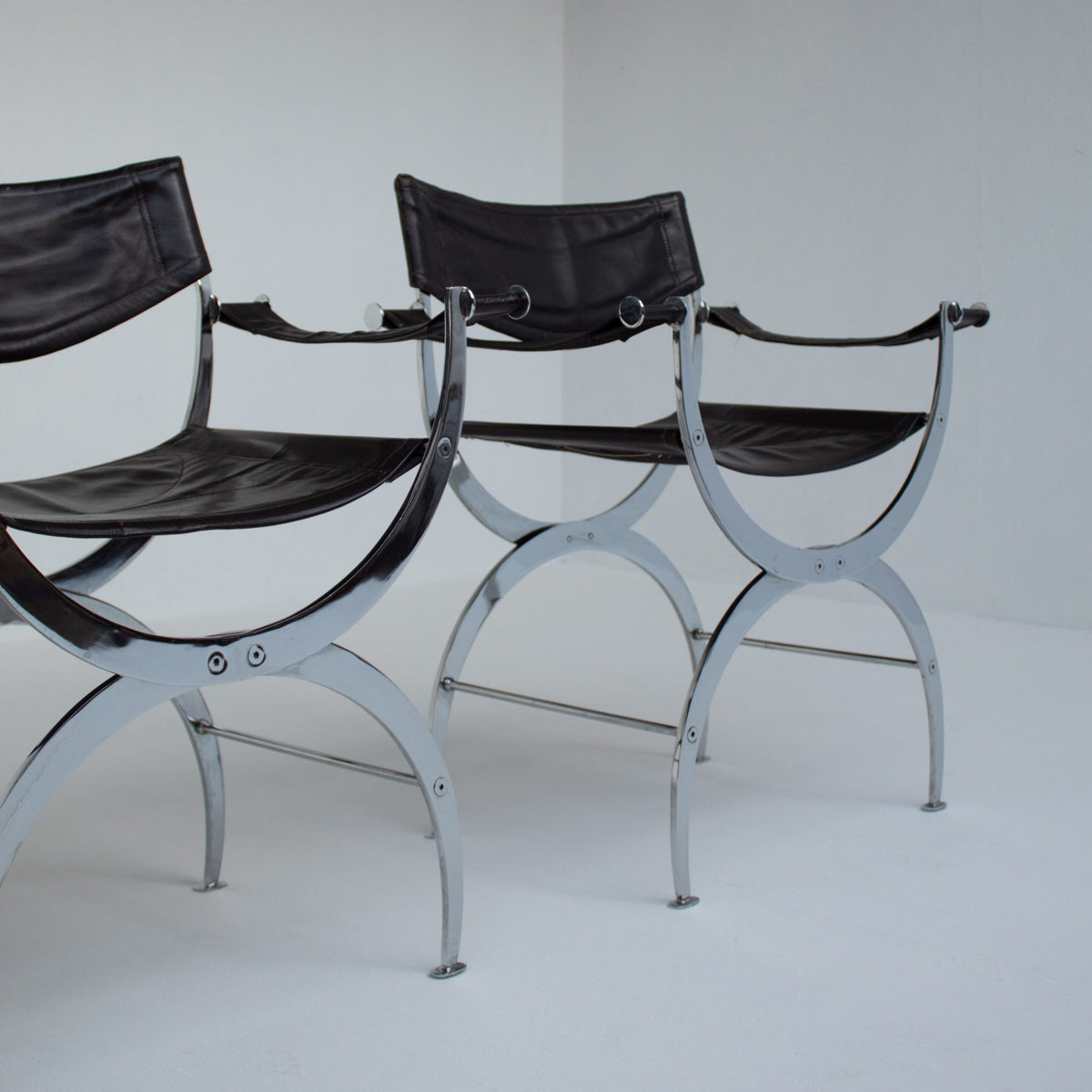 Set of 6 Italian Chrome Dining Chairs with Leather Seating — angled view highlighting chrome frame and black leather