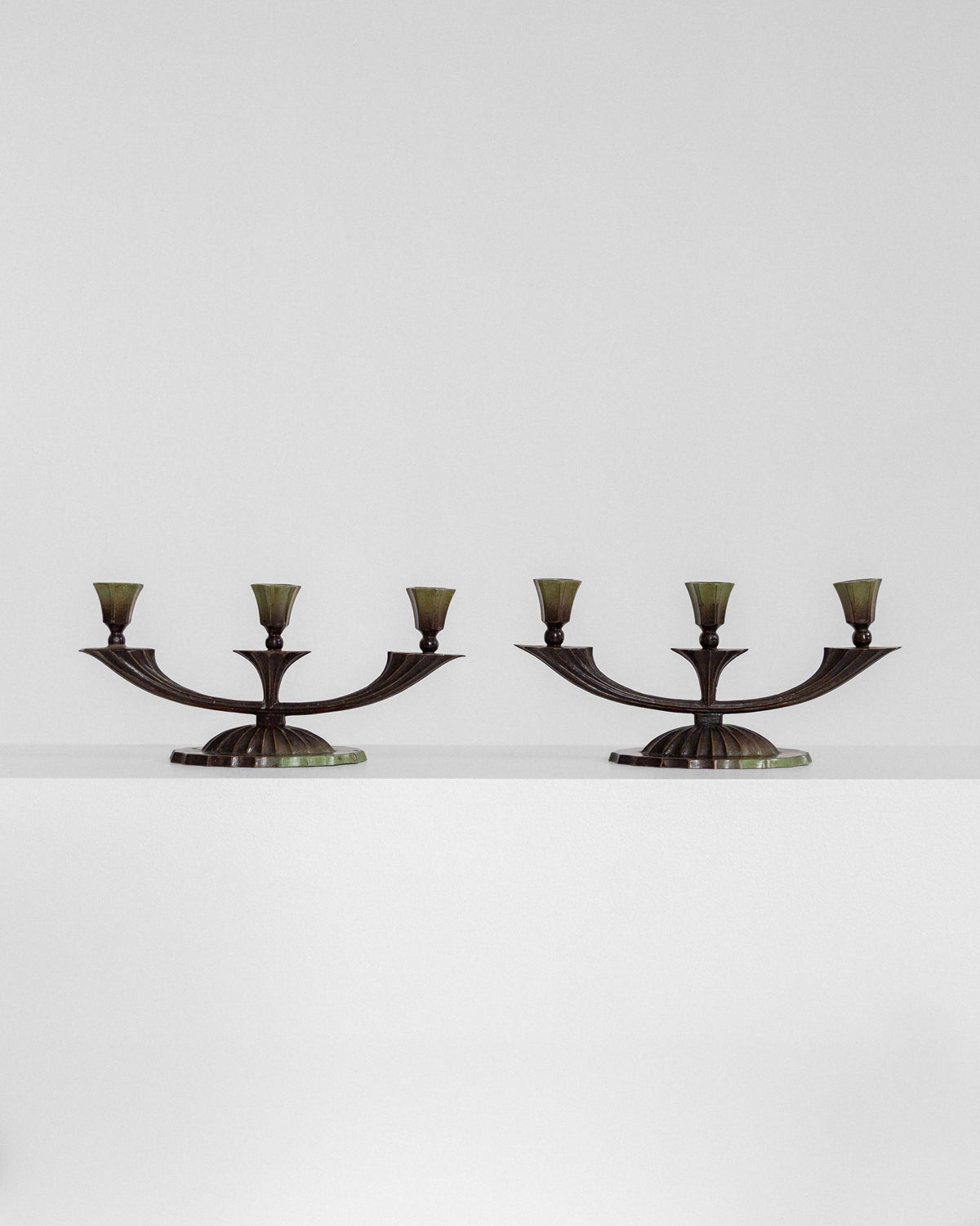Pair of Art Deco bronze candelabras with curved arms, 1930s Sweden