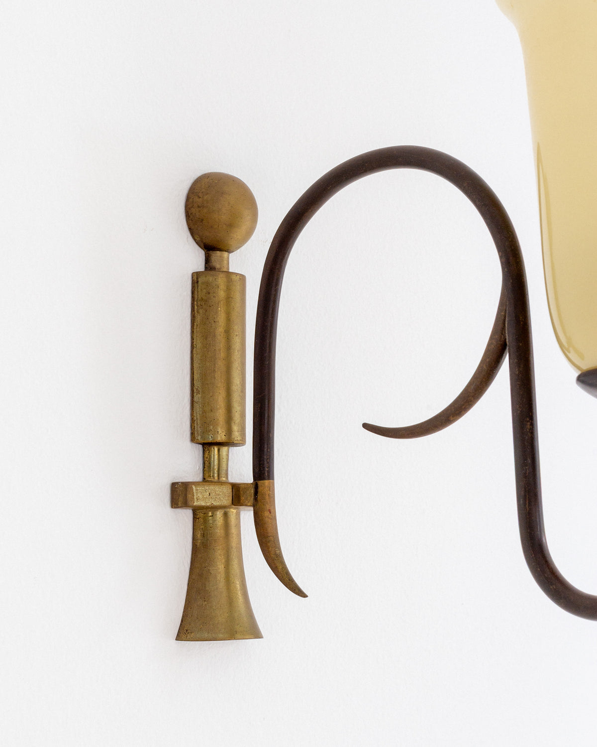 Brass wall sconce pump mechanism detail with curved tubing