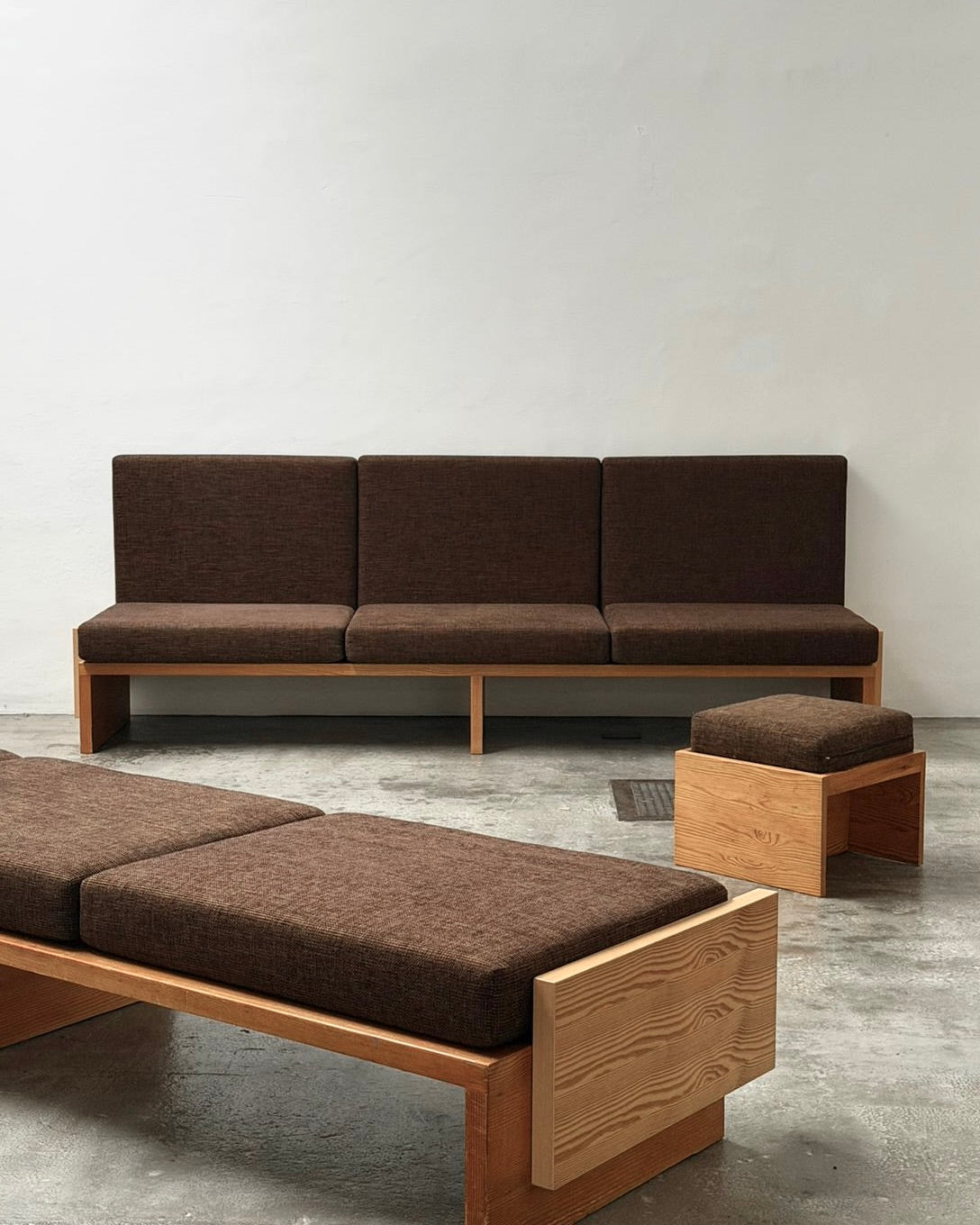 Modernist Benches and Stool, c.1970 — brown upholstered seating in minimalist interior