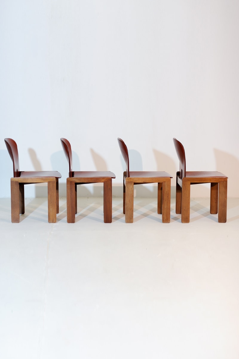 Four walnut 121 dining chairs by Scarpa for Cassina in profile