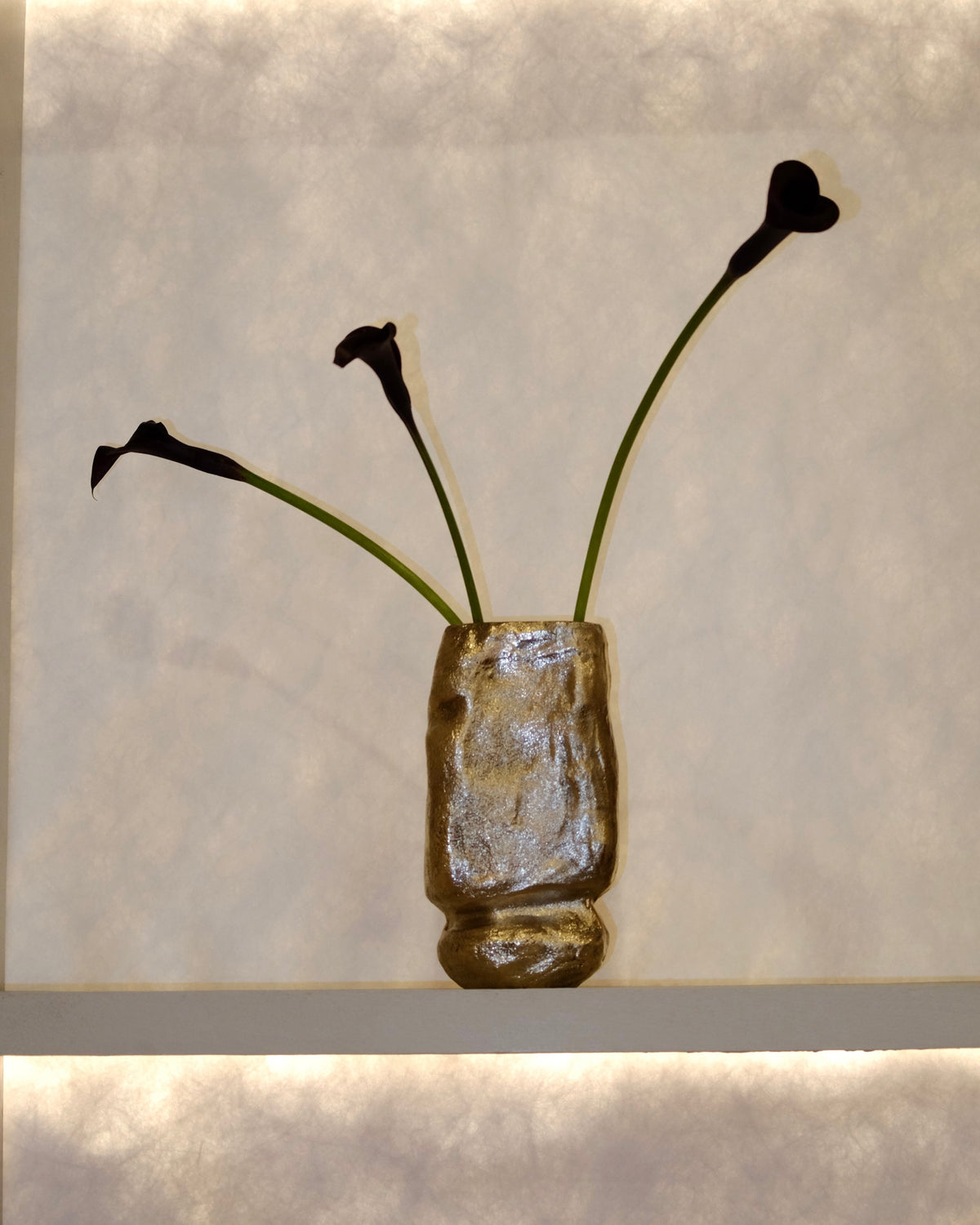 OLIO Vase No. 3 by Maha Alavi, textured gold ceramic with dark calla lilies
