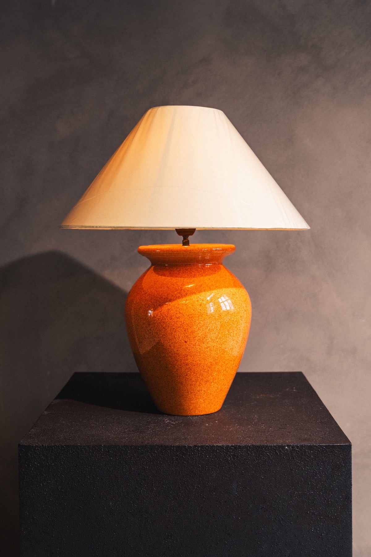 Orange ceramic table lamp base with cream shade by Robert Kostka