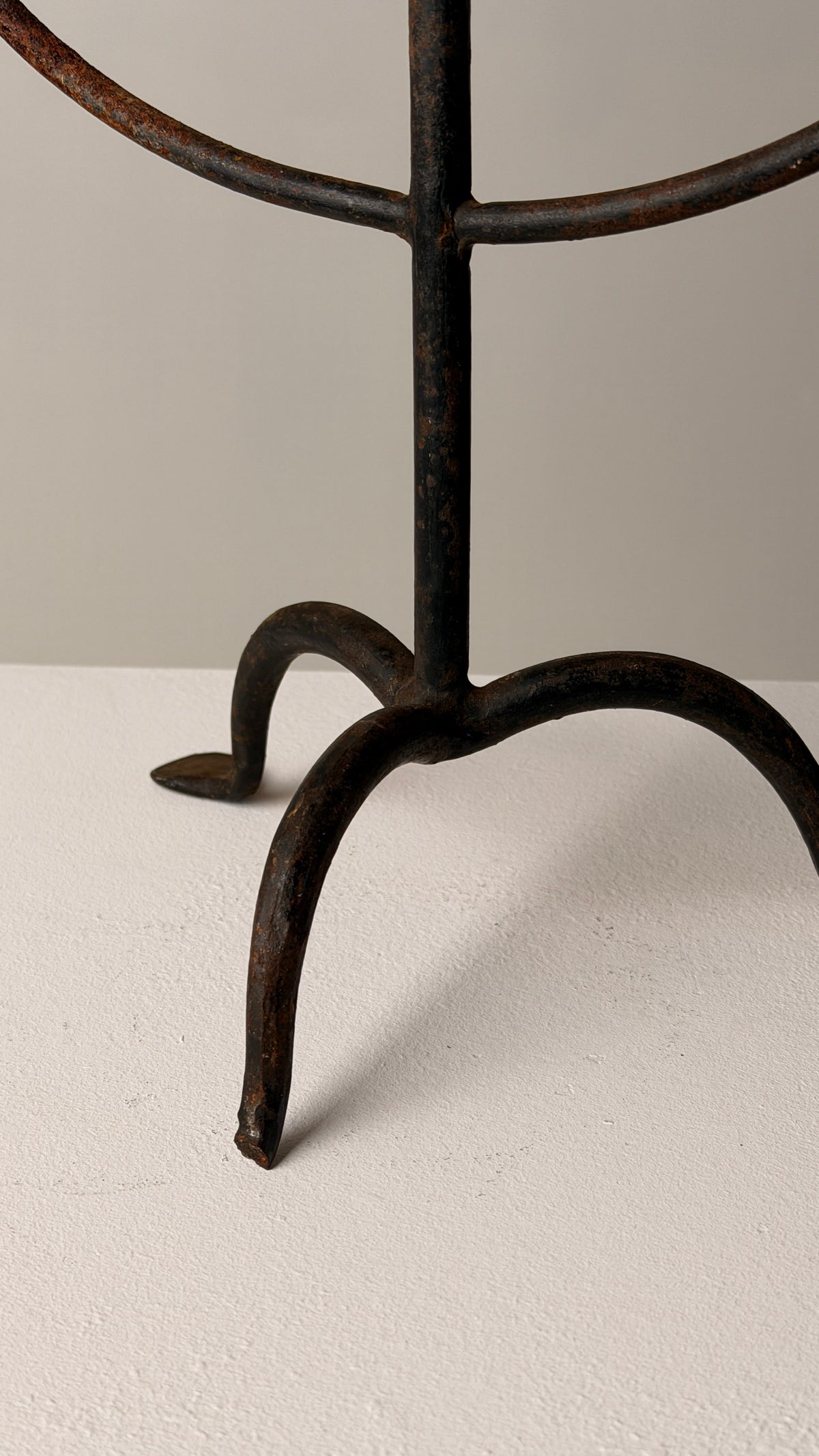 Wrought Iron Candelabrum, France, early 20th century — close-up of base on textured surface
