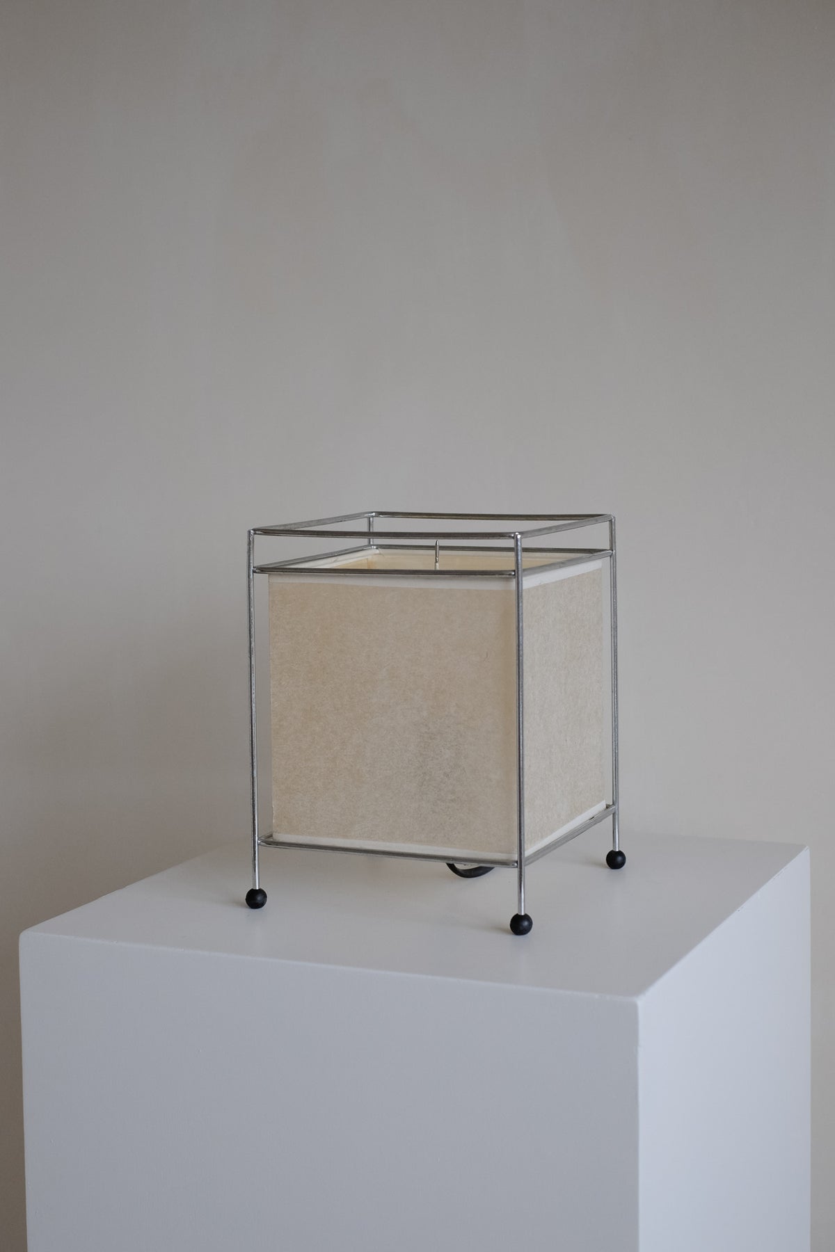 Japanese Rice Paper Table Lamp — side angle on white pedestal
