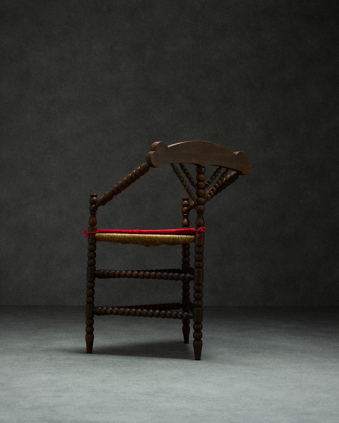 triangular bobbin chair — back view with dark wood and woven seat