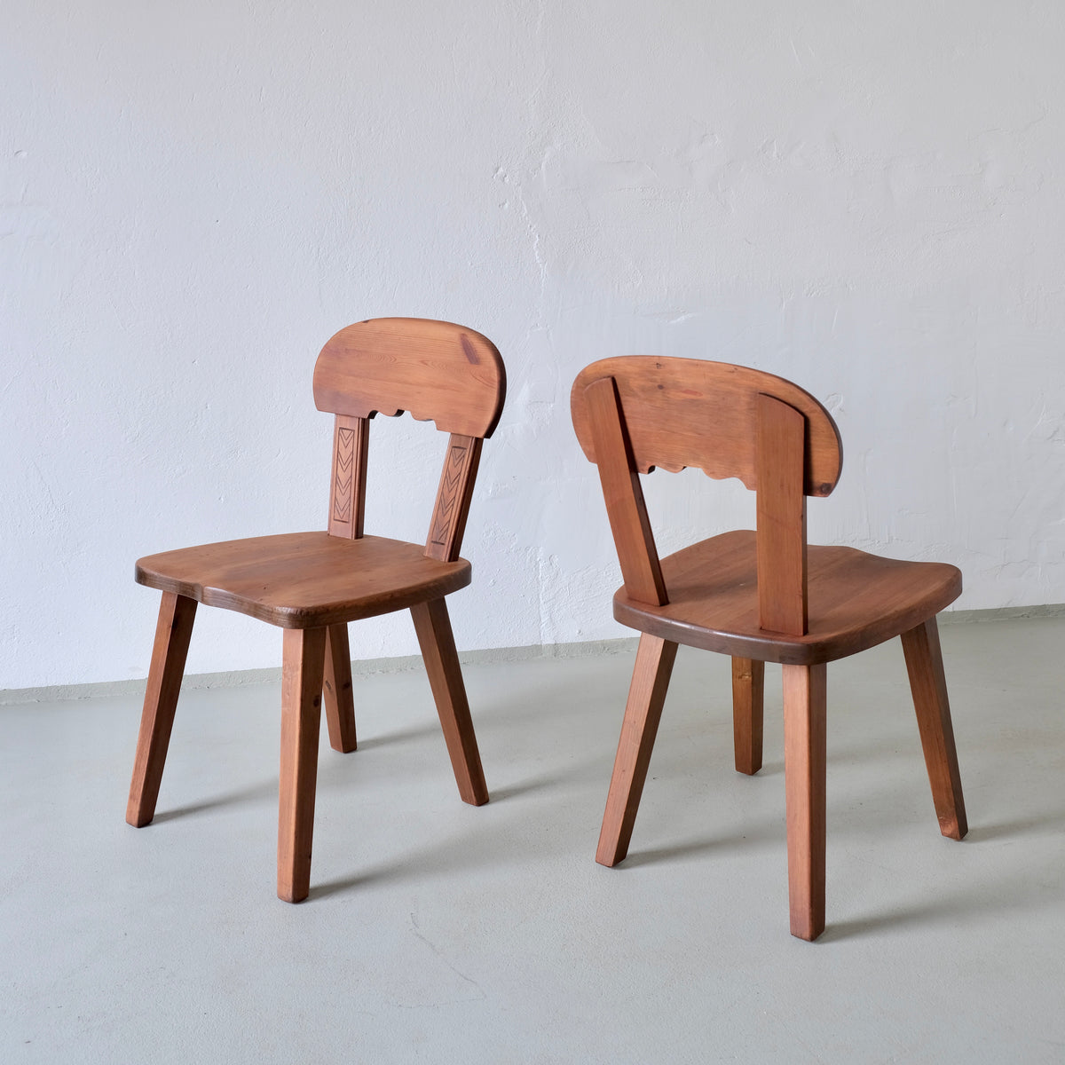 Two rustic Swedish pine chairs from 1940s with carved details