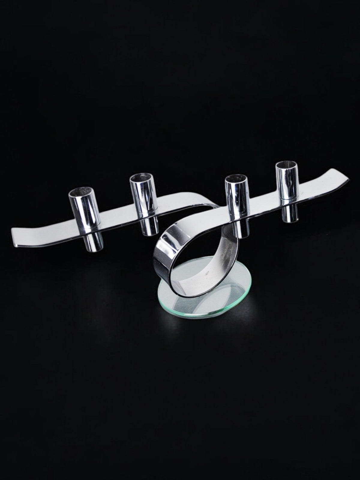 Space-age 4-flame candlestick, glass and metal, Germany, 1980 — side angle on black background