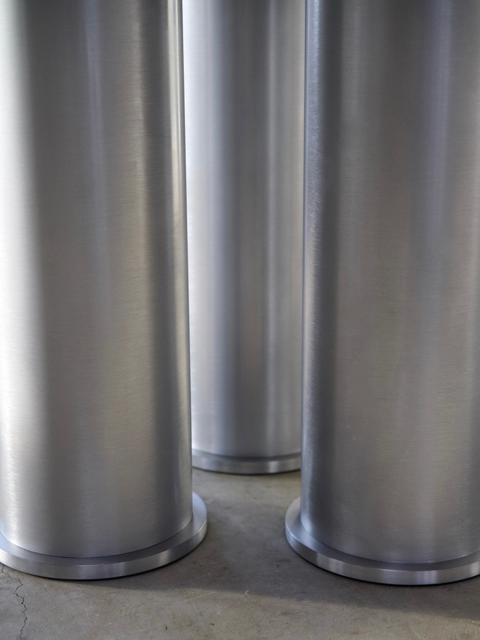 Elephant Table (Dining) — back view of brushed aluminum legs