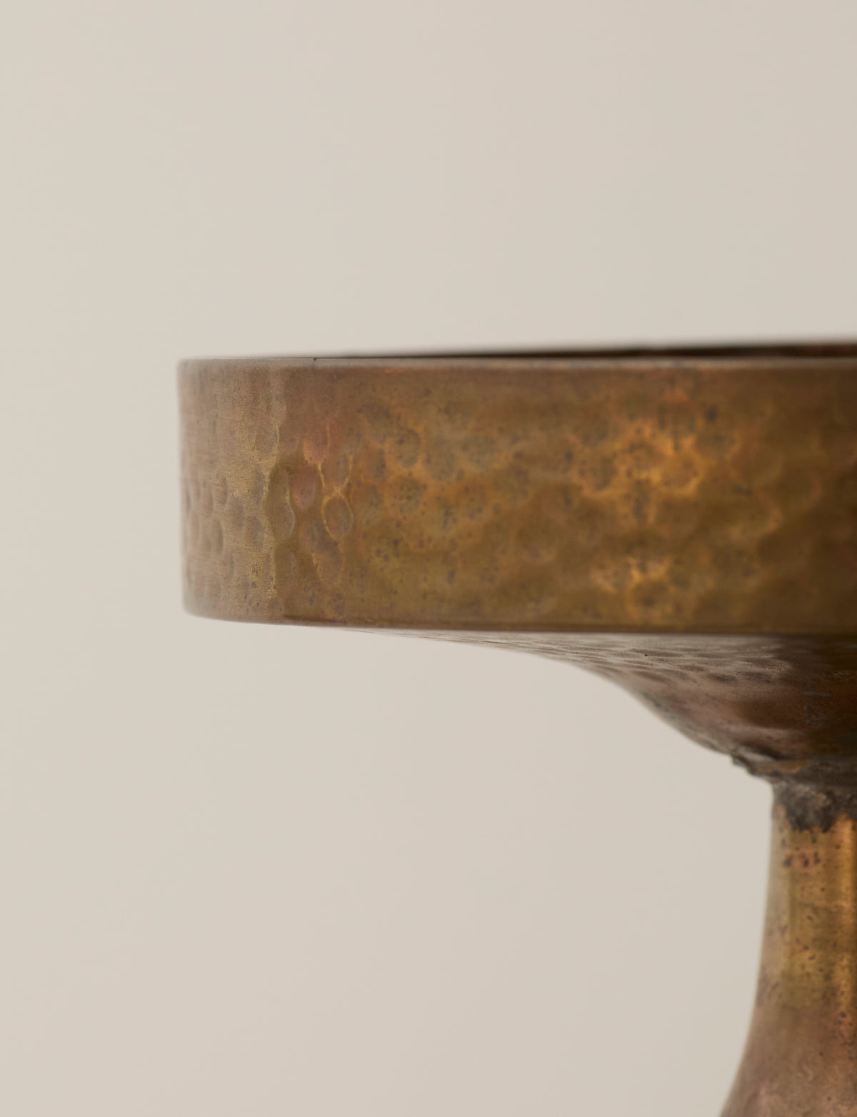 Metal Pedestal Bowl — close-up of hammered brass surface