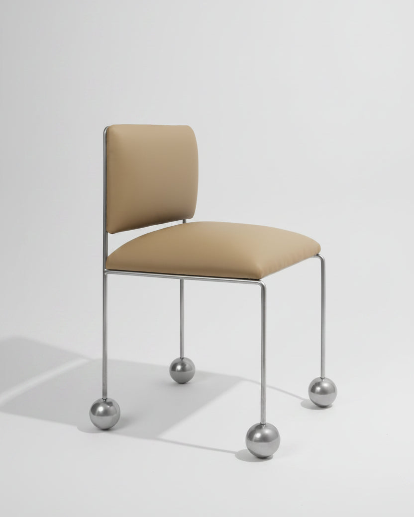 Ball Foot Sculptural Chair in (vegan) leather — side angle