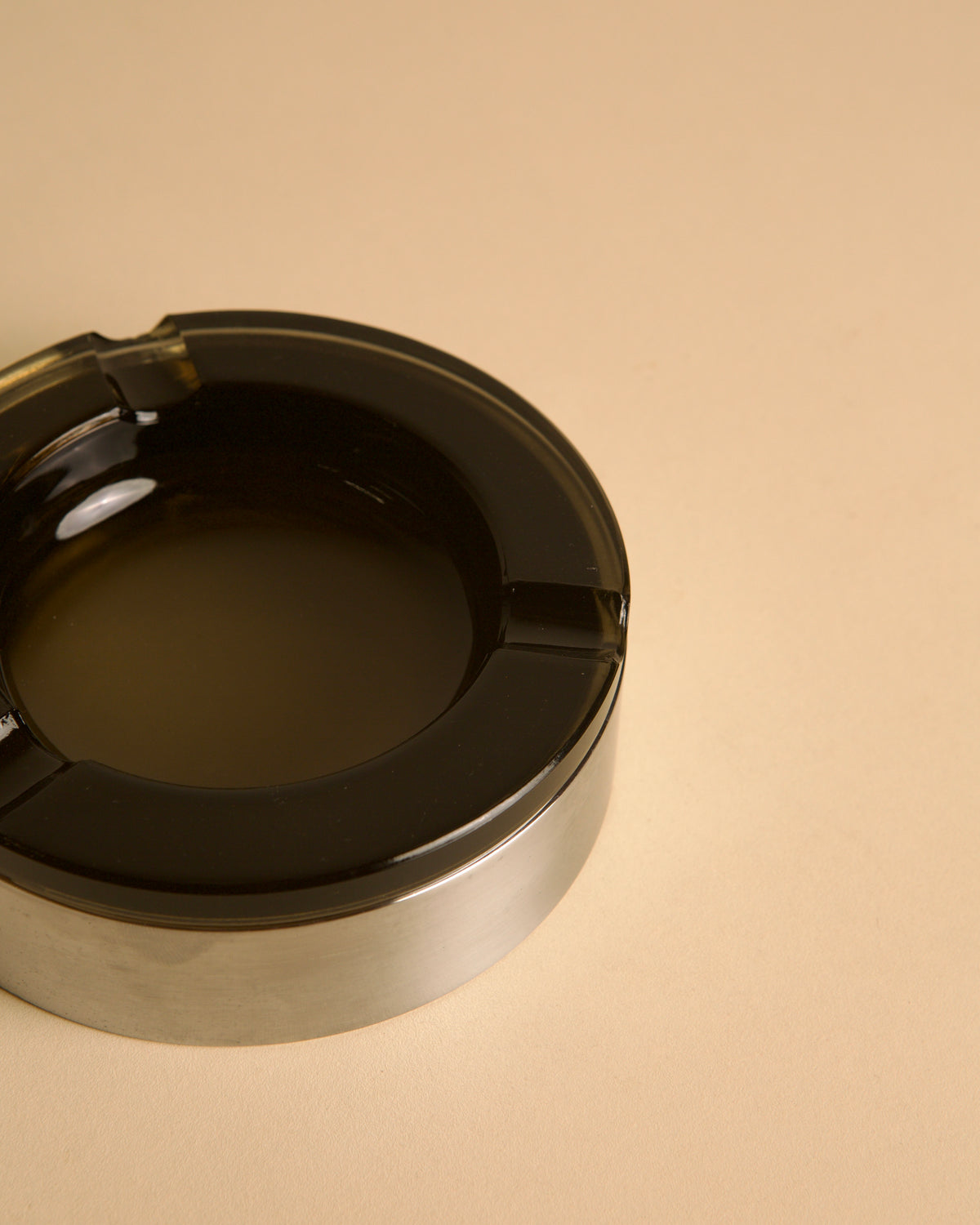 Italian circular metal and amber glass ashtray, 1970s — side angle