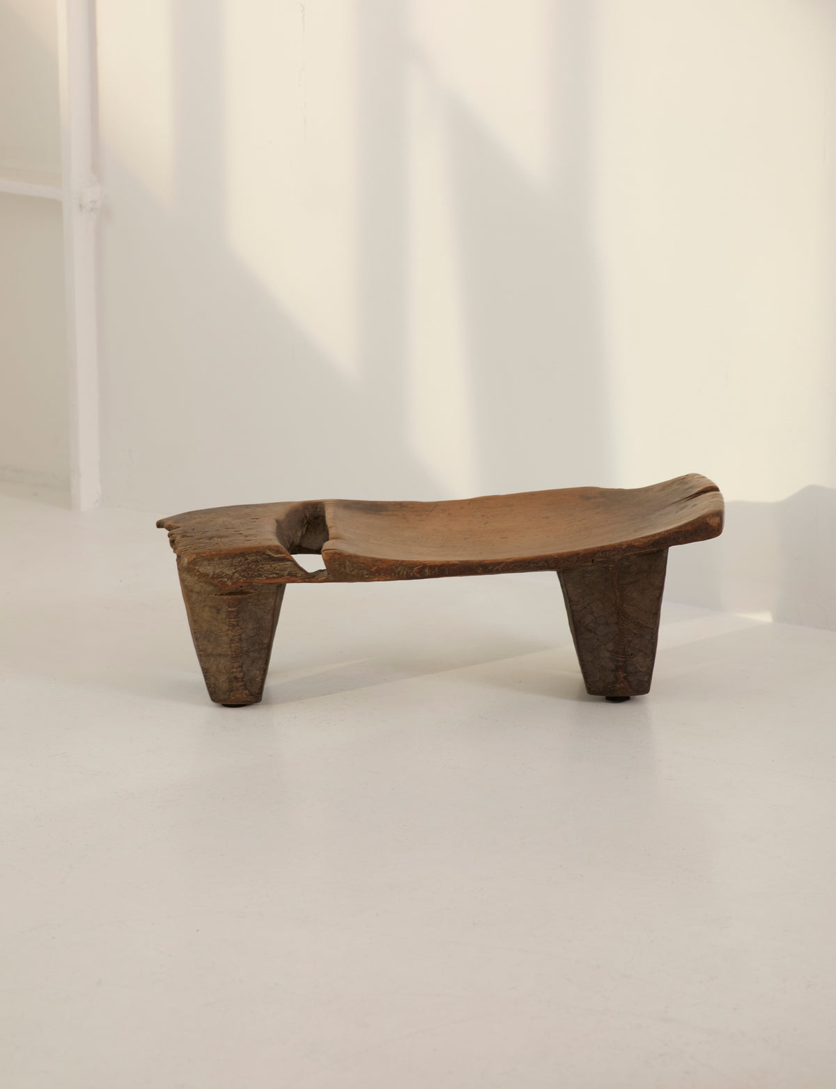 Mid-Century African Senufo Stool / Side Table in Solid Wood — side angle showing natural wood grain and legs