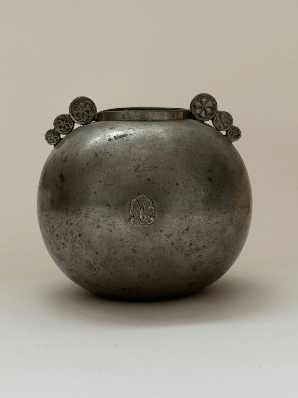 Swedish Grace Spherical Pewter Vase, 1934 — side angle showing decorative flower motifs