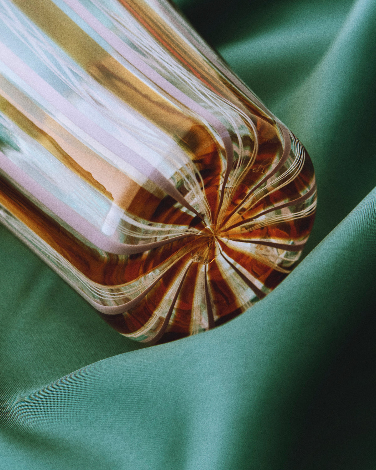 Clara Glasses - Set of four — close-up of amber glass on green fabric