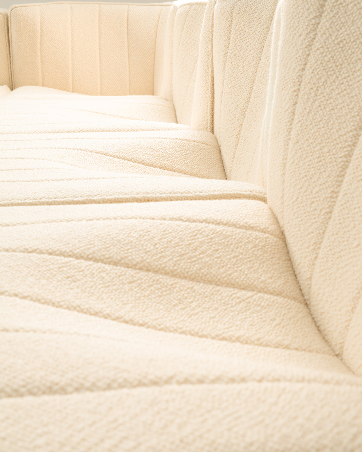 Cream modular sofa corner detail showing quilted upholstery