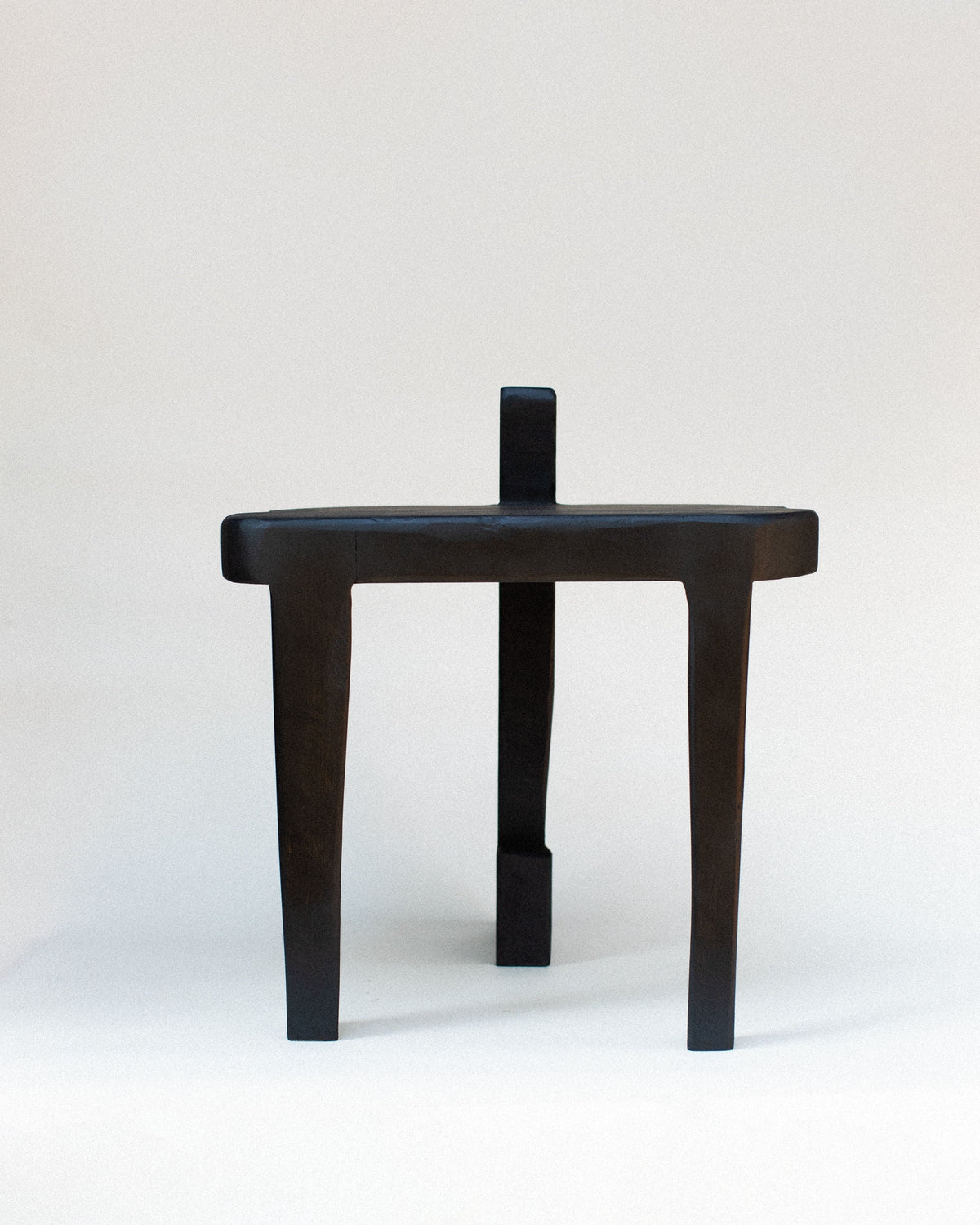 Sharie black wooden stool with minimalist three-leg design