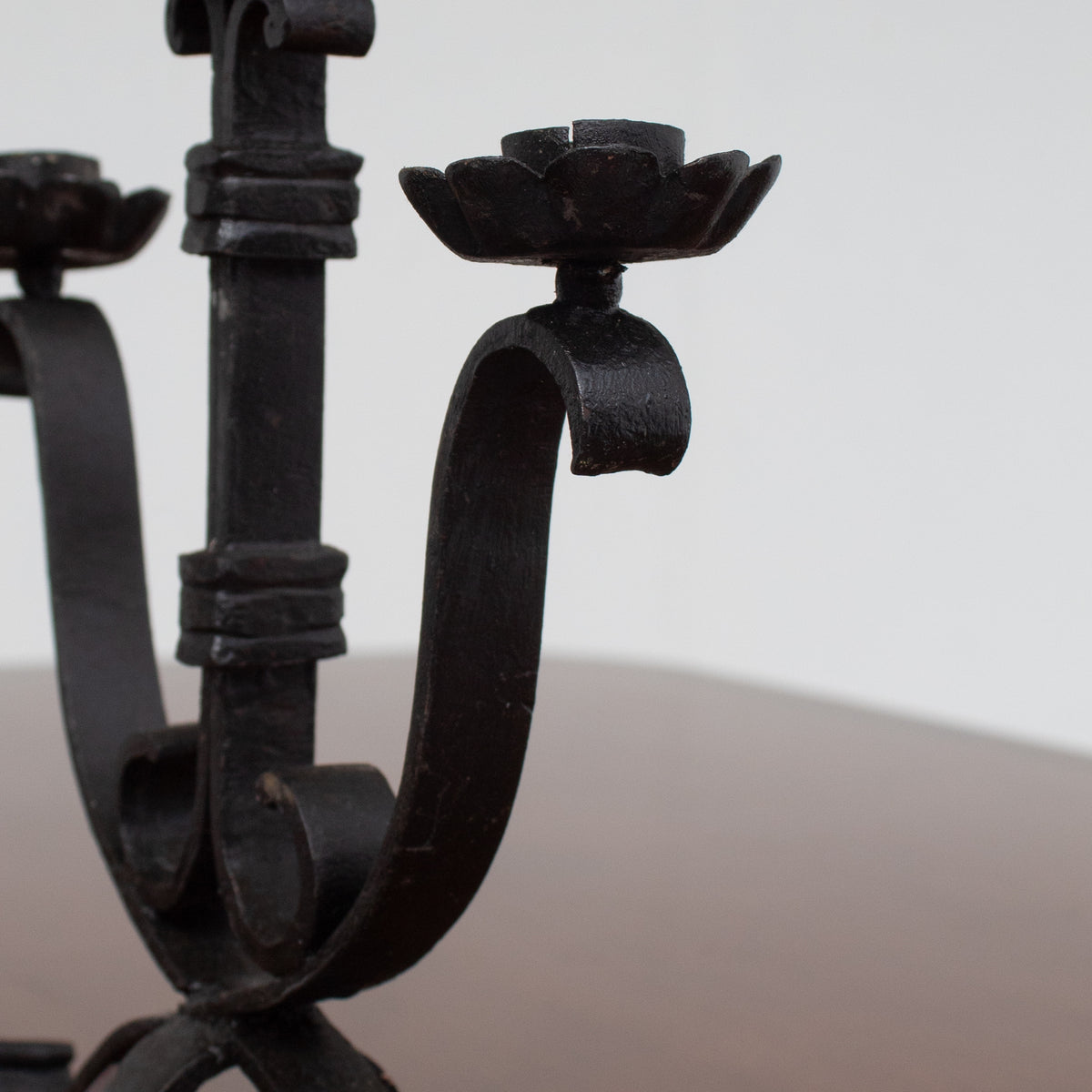 Pair of Brutalist Iron Candleholders with Sculptural Scroll Arms — lifestyle setting
