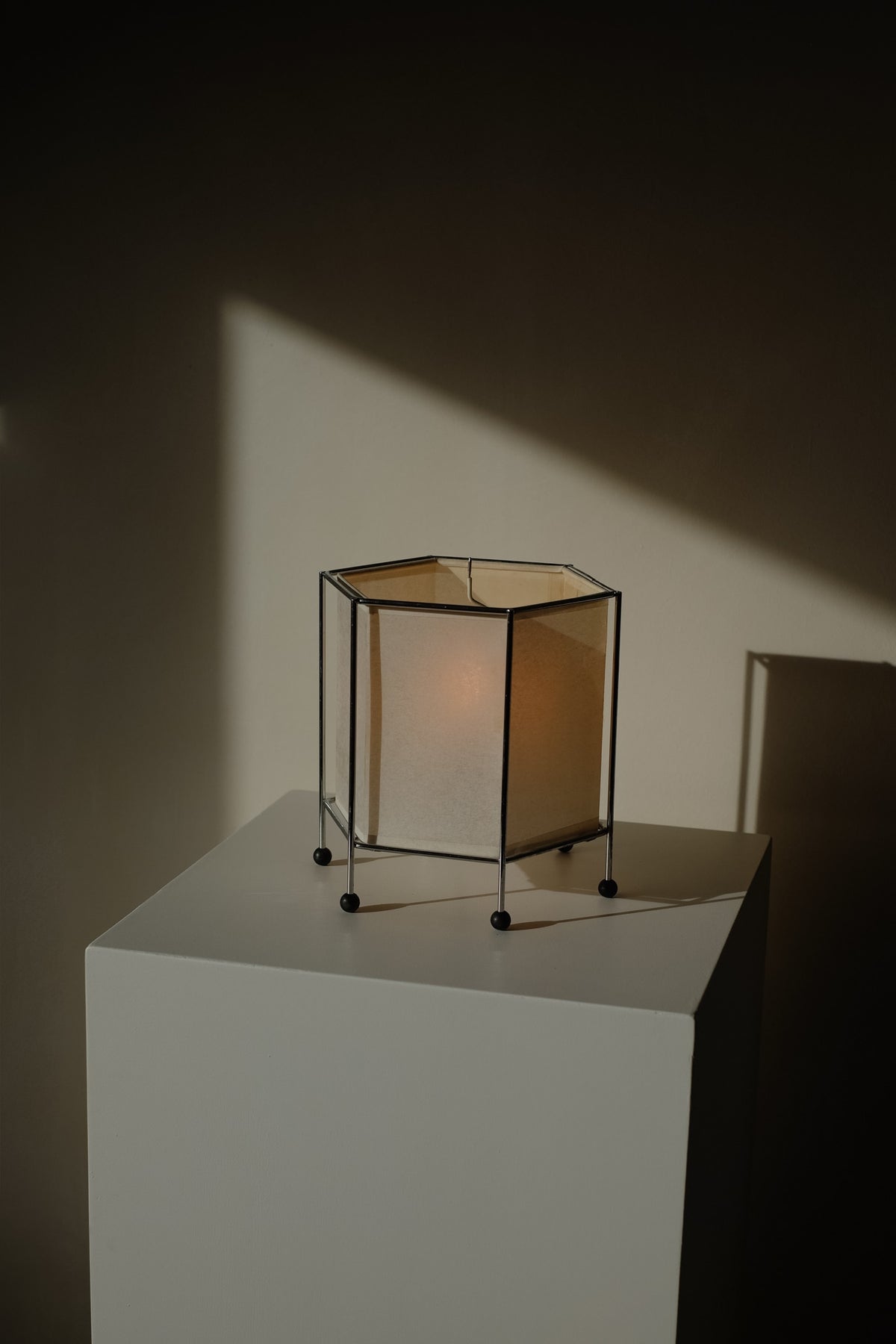 Japanese Rice Paper Table Lamp — top view on white pedestal