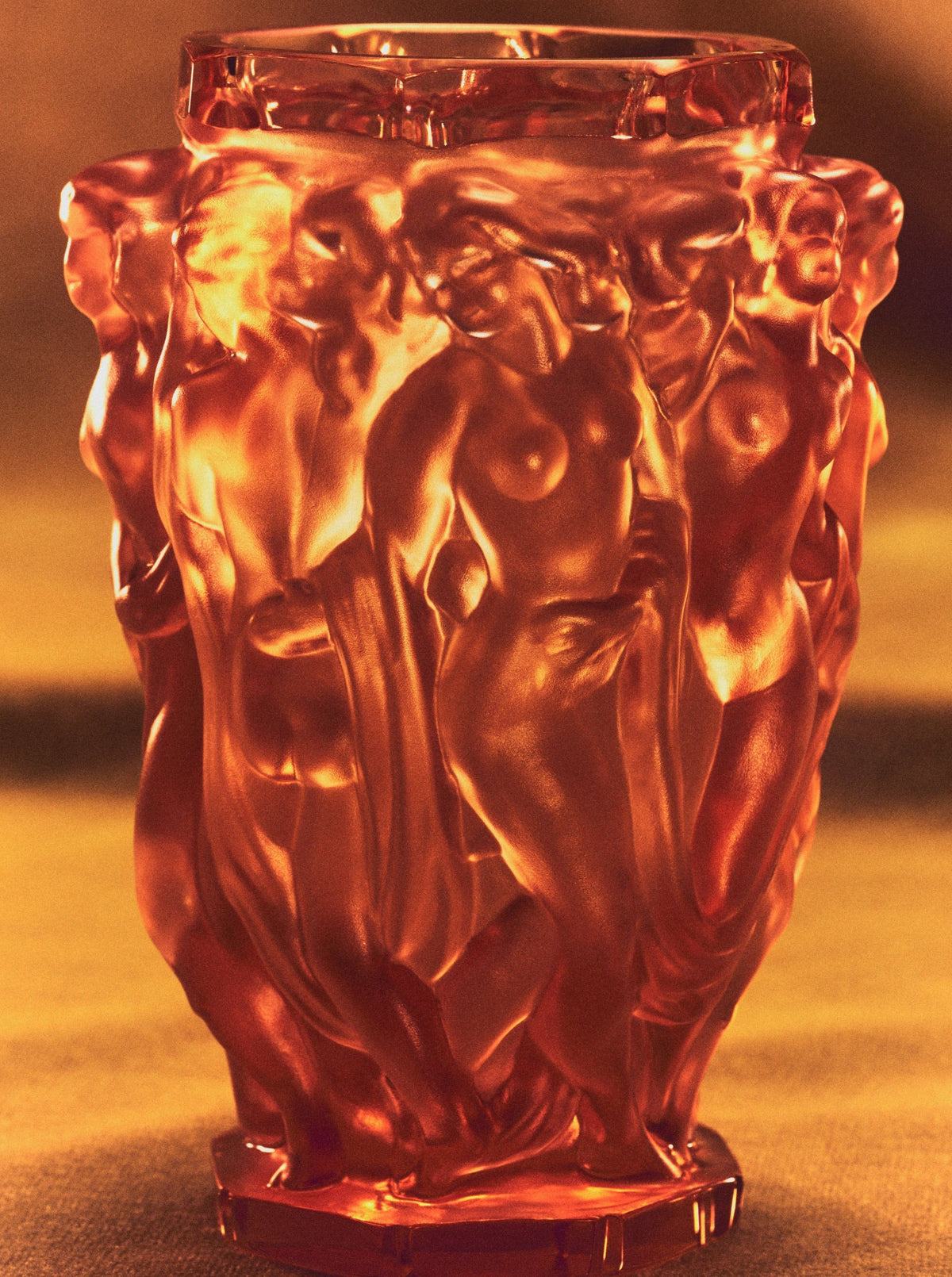 Michael Vase — close-up of amber glass with detailed figures