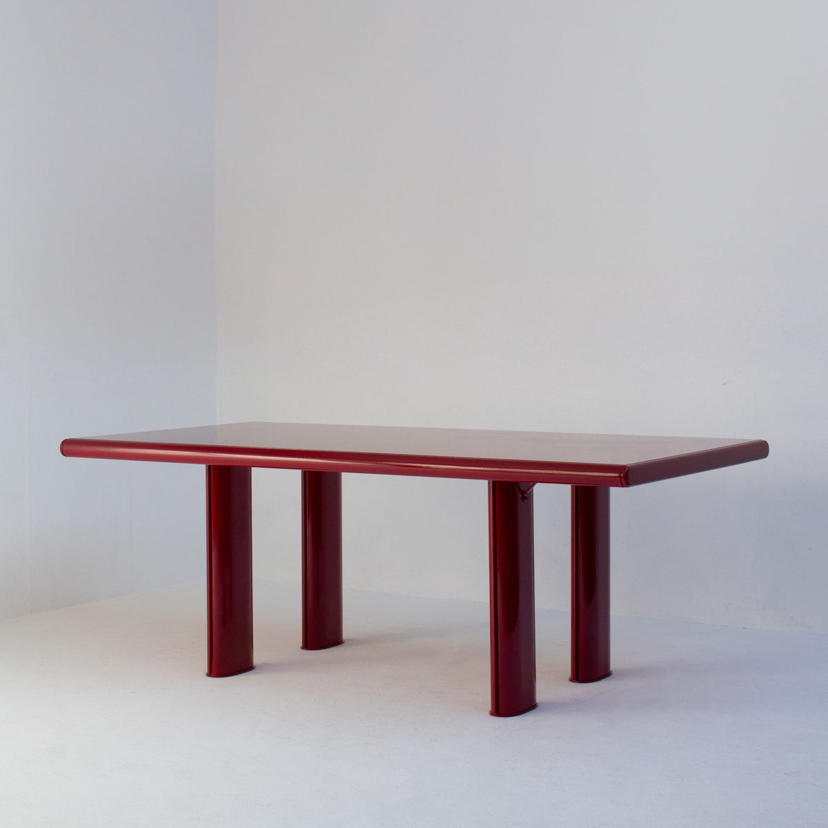 Red Lacquered Dining Table in Wood and Metal — angled view highlighting glossy red finish