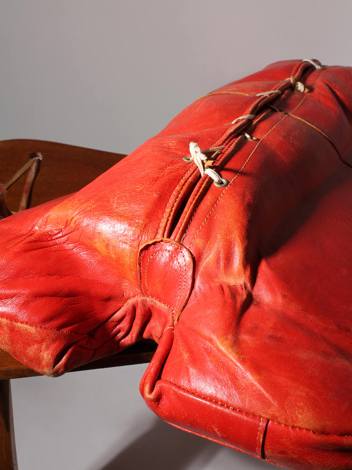 Egyptian Ottoman Camel Saddle Stool — close-up of red leather texture
