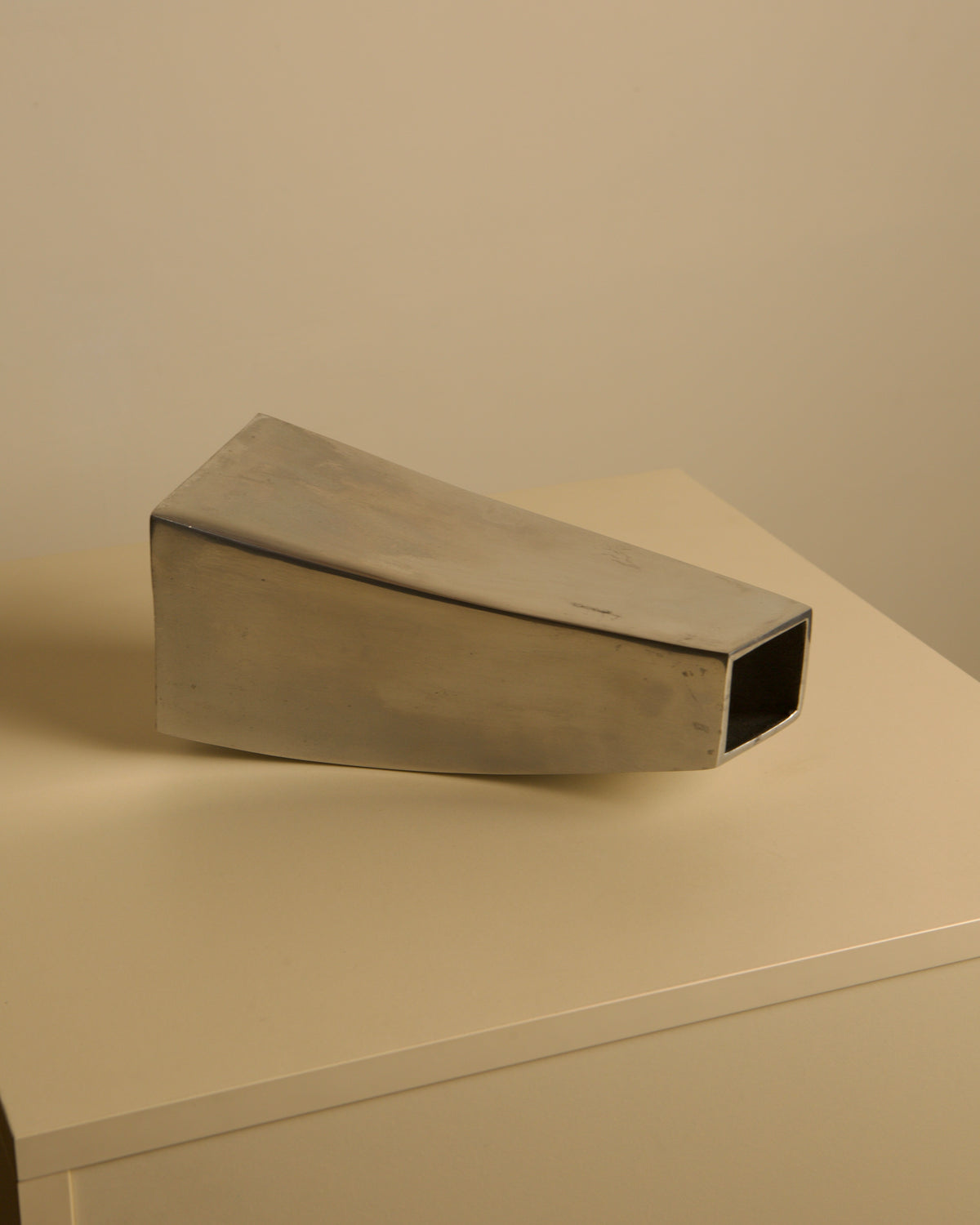 Corne vase in cast aluminum, 80s — angled view on neutral background