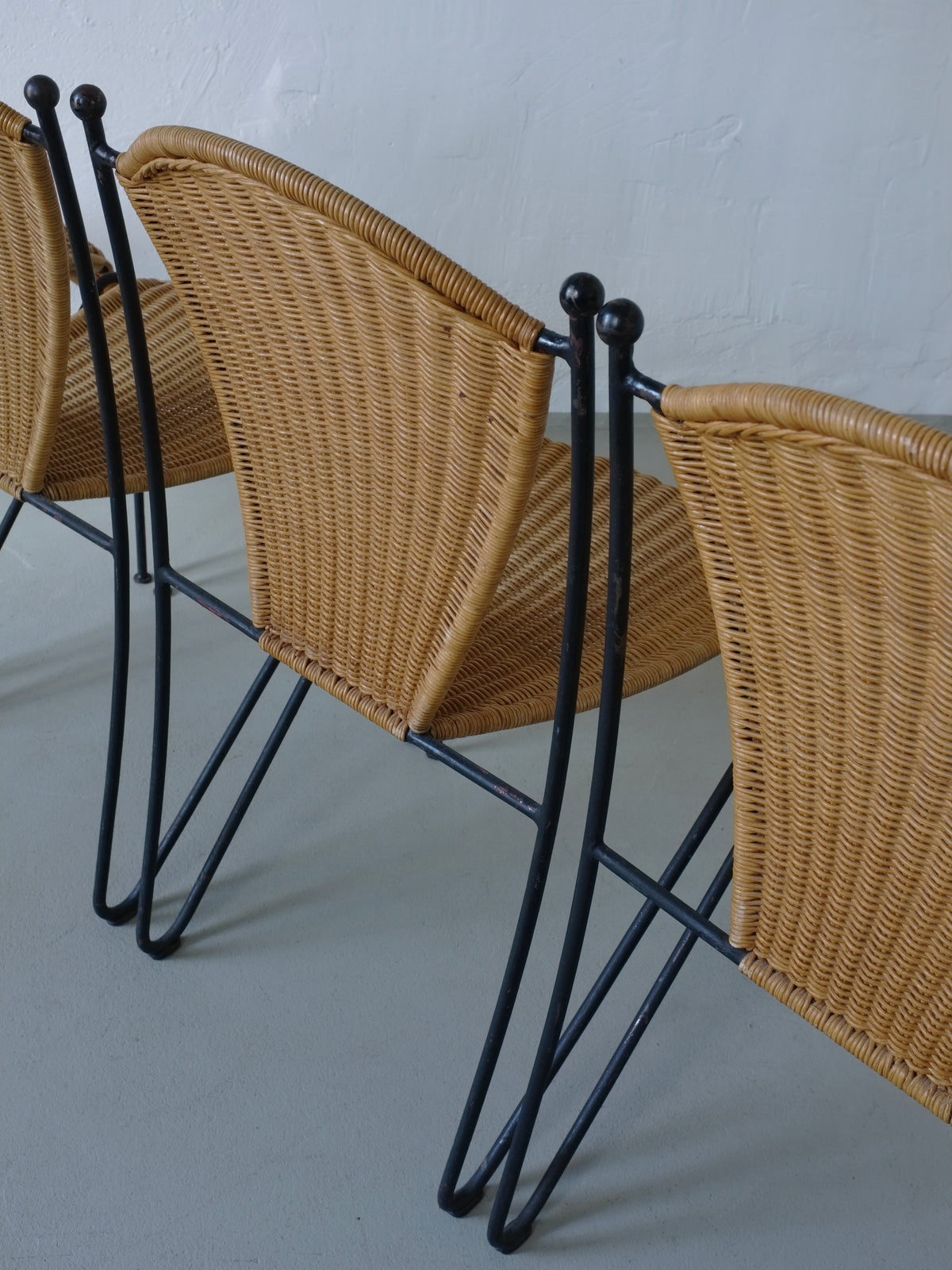 Wicker and iron chair construction detail showing woven seat