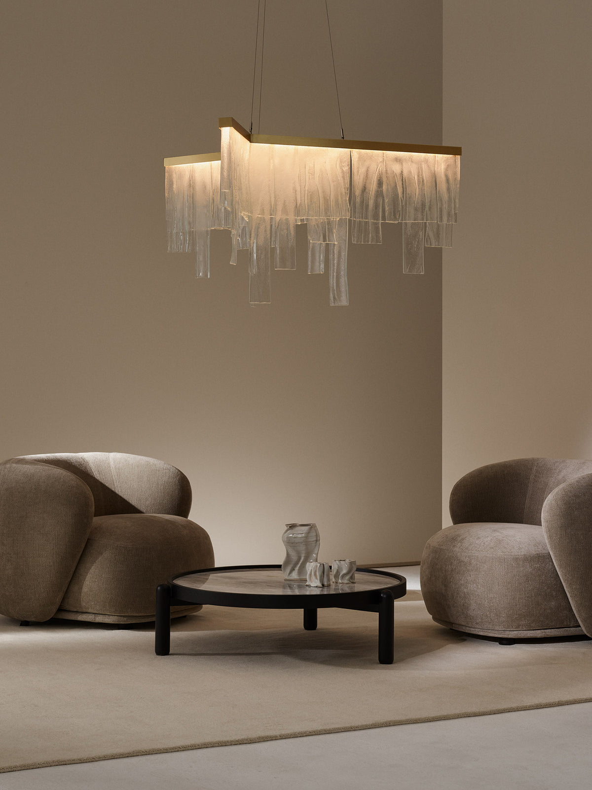 CASCATA Chandelier With Ceiling Rose — hanging above modern beige armchairs