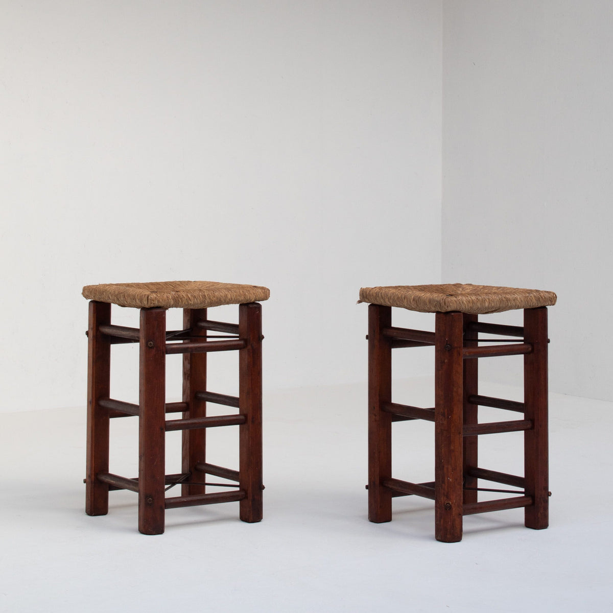 Pair of Rustic Wooden Stools with Woven Rush Seats — side angle showing sturdy wooden legs