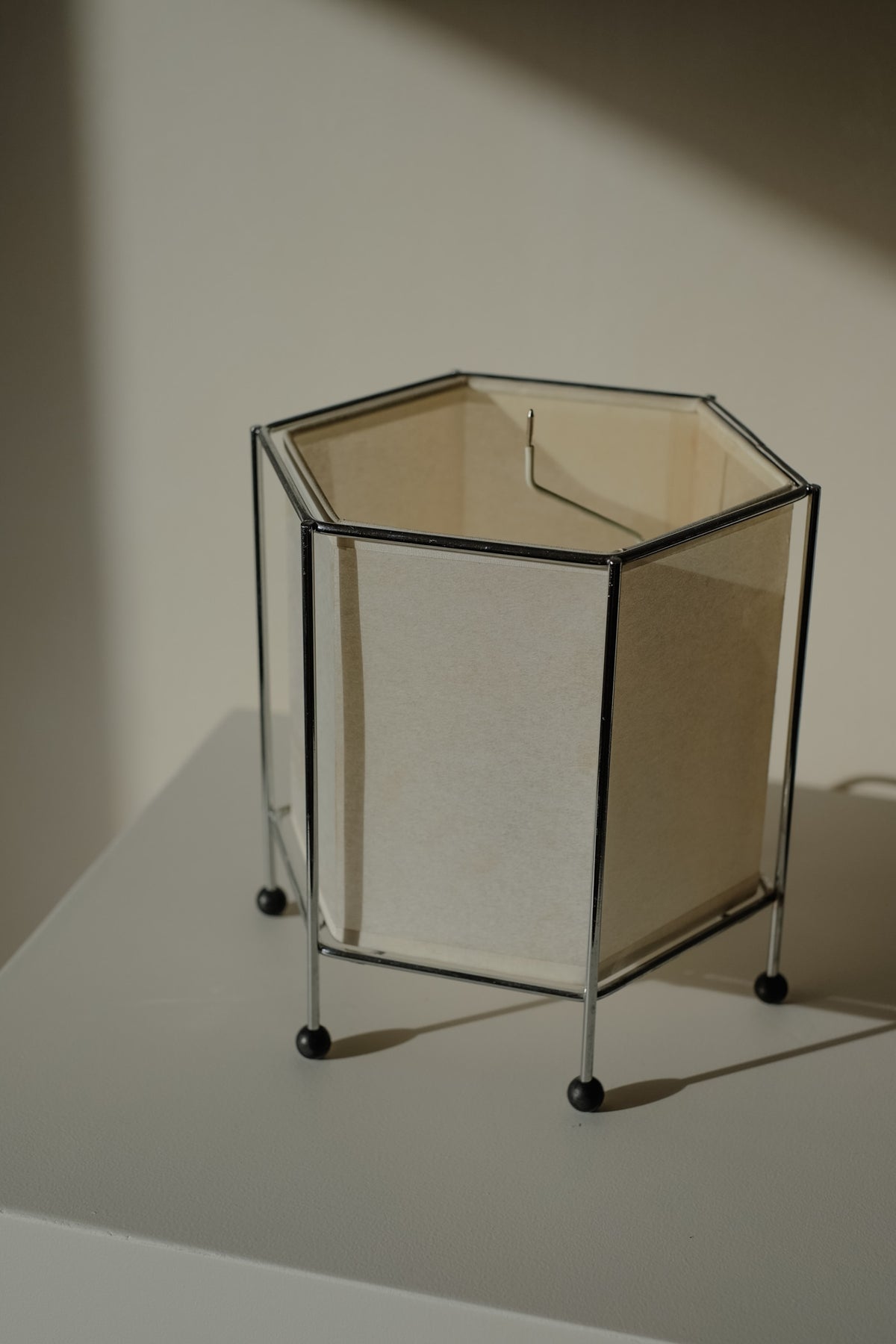 Japanese Rice Paper Table Lamp — angled view on white pedestal
