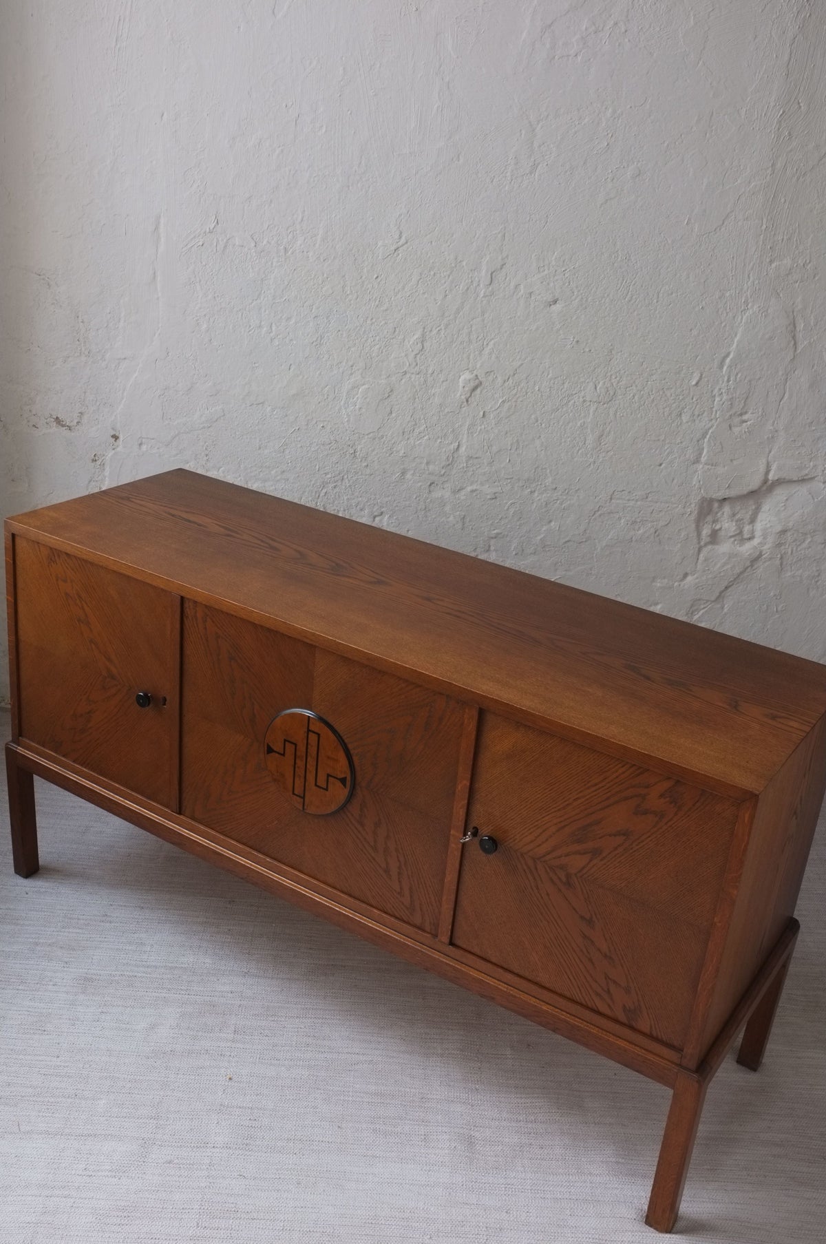 Swedish Modern Oak Sideboard, 1930s — angled view of oak cabinet with decorative doors