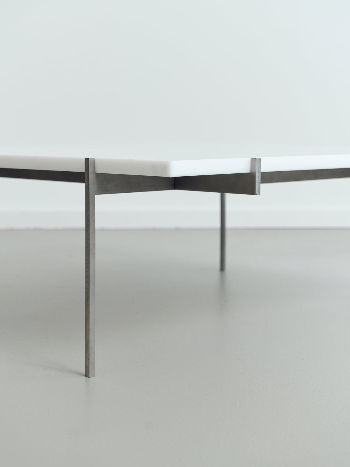 Lightweight Lounge Table — side angle showing white top and metal legs