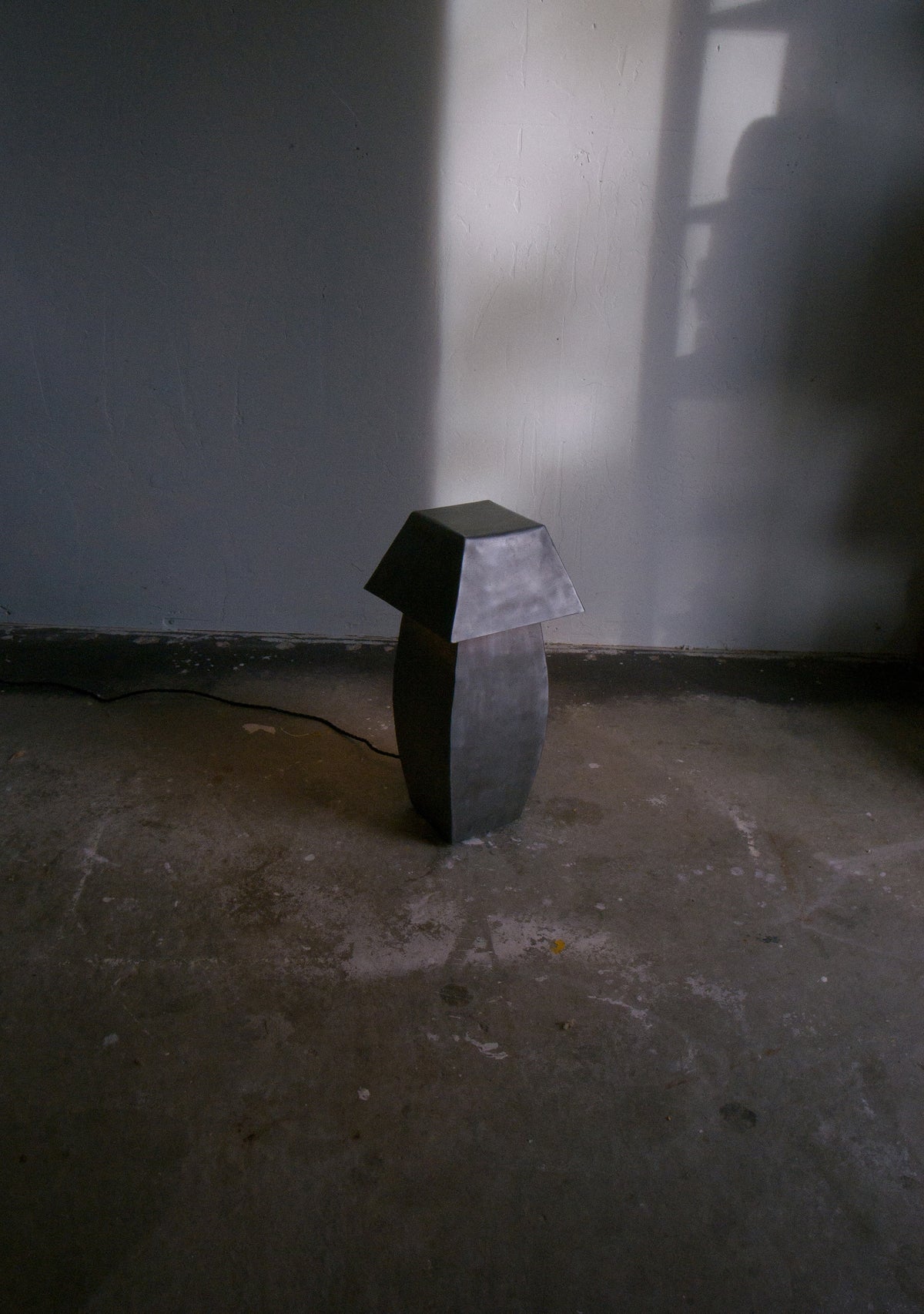 Tall hammered steel table lamp with geometric faceted design
