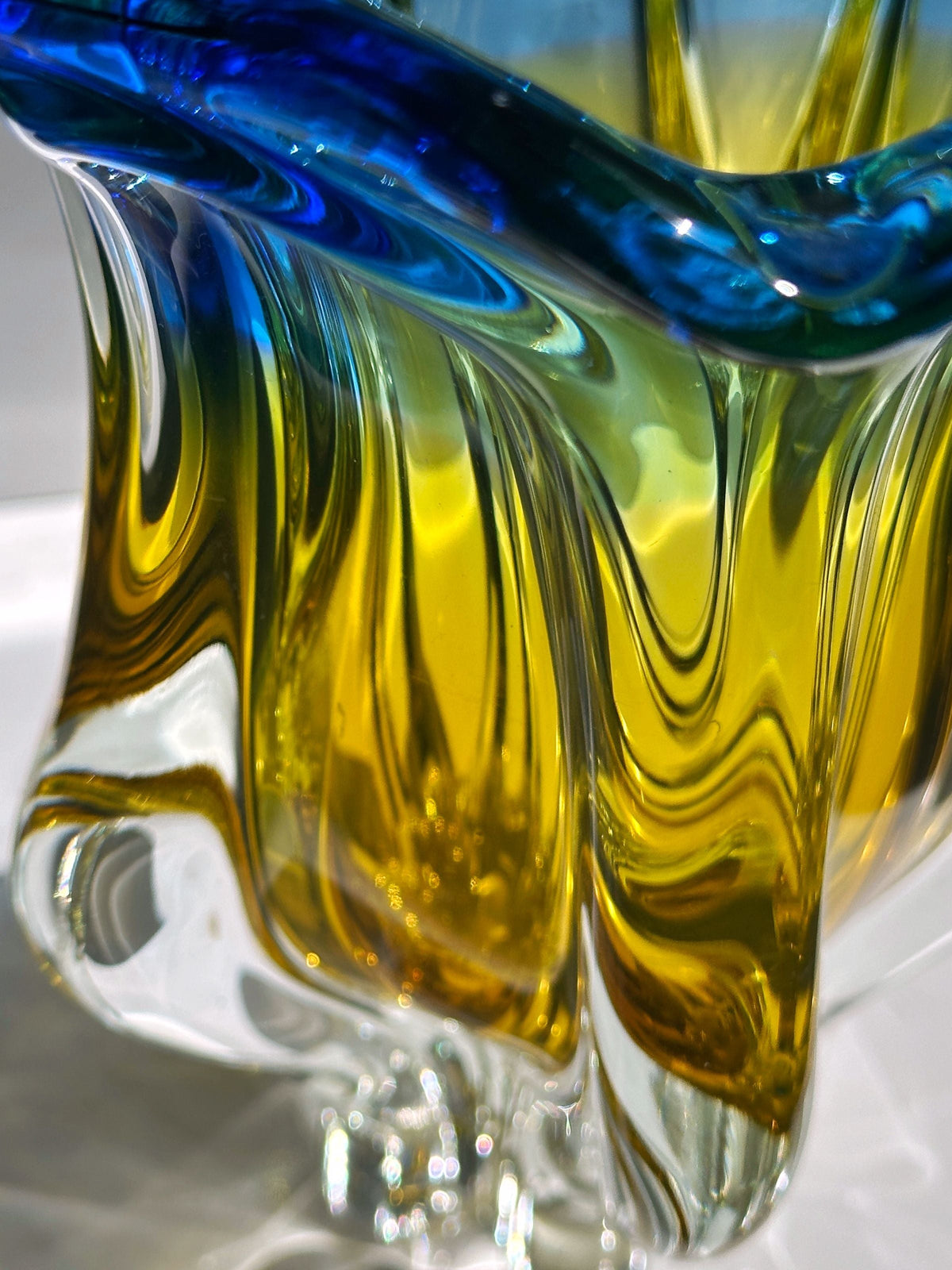 Close-up detail of amber and blue swirled Bohemian glass vase