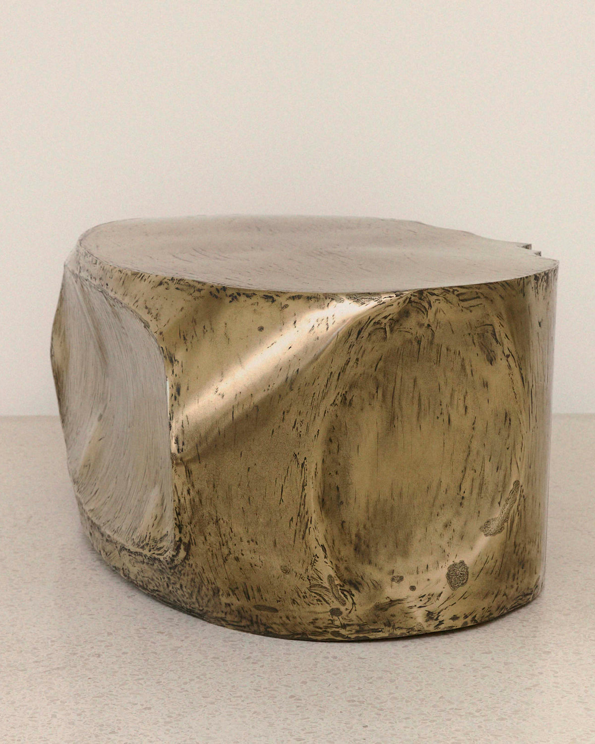 ROCHER brass resin coffee table with sculptural curved form