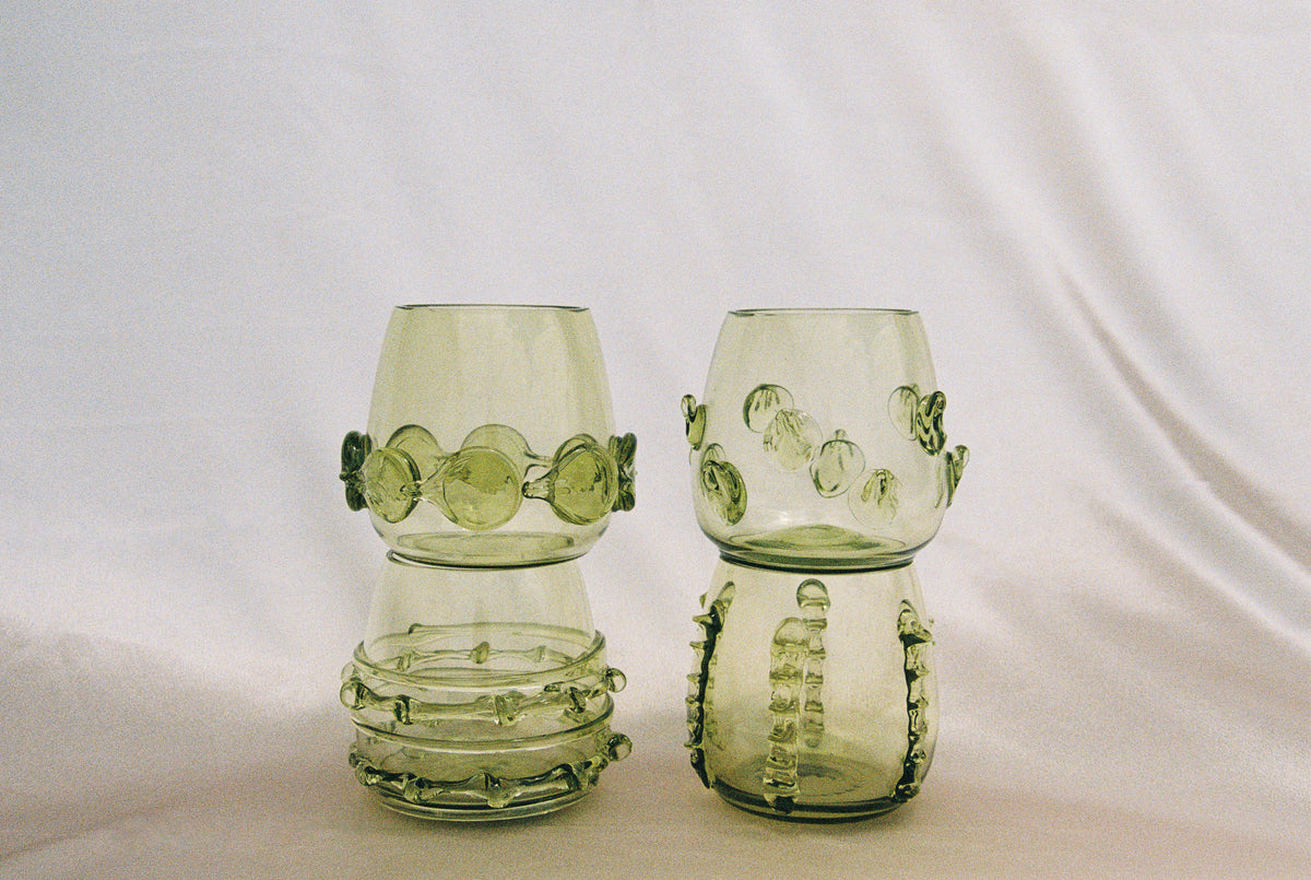 Contemporary Tumblr - Set of four handblown glass vessels - stacked on soft fabric background